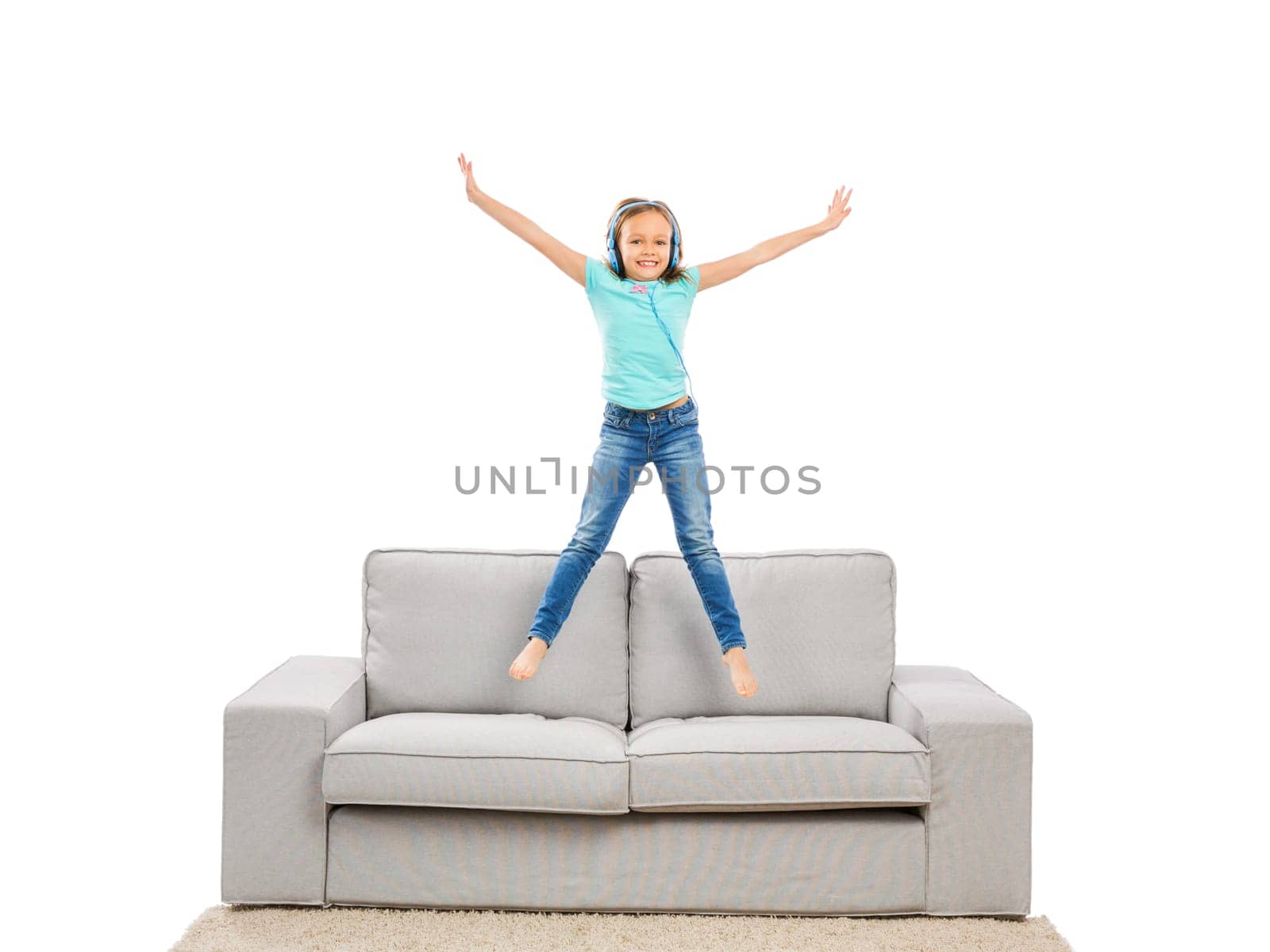 Cute blonde girl jumping and listen music