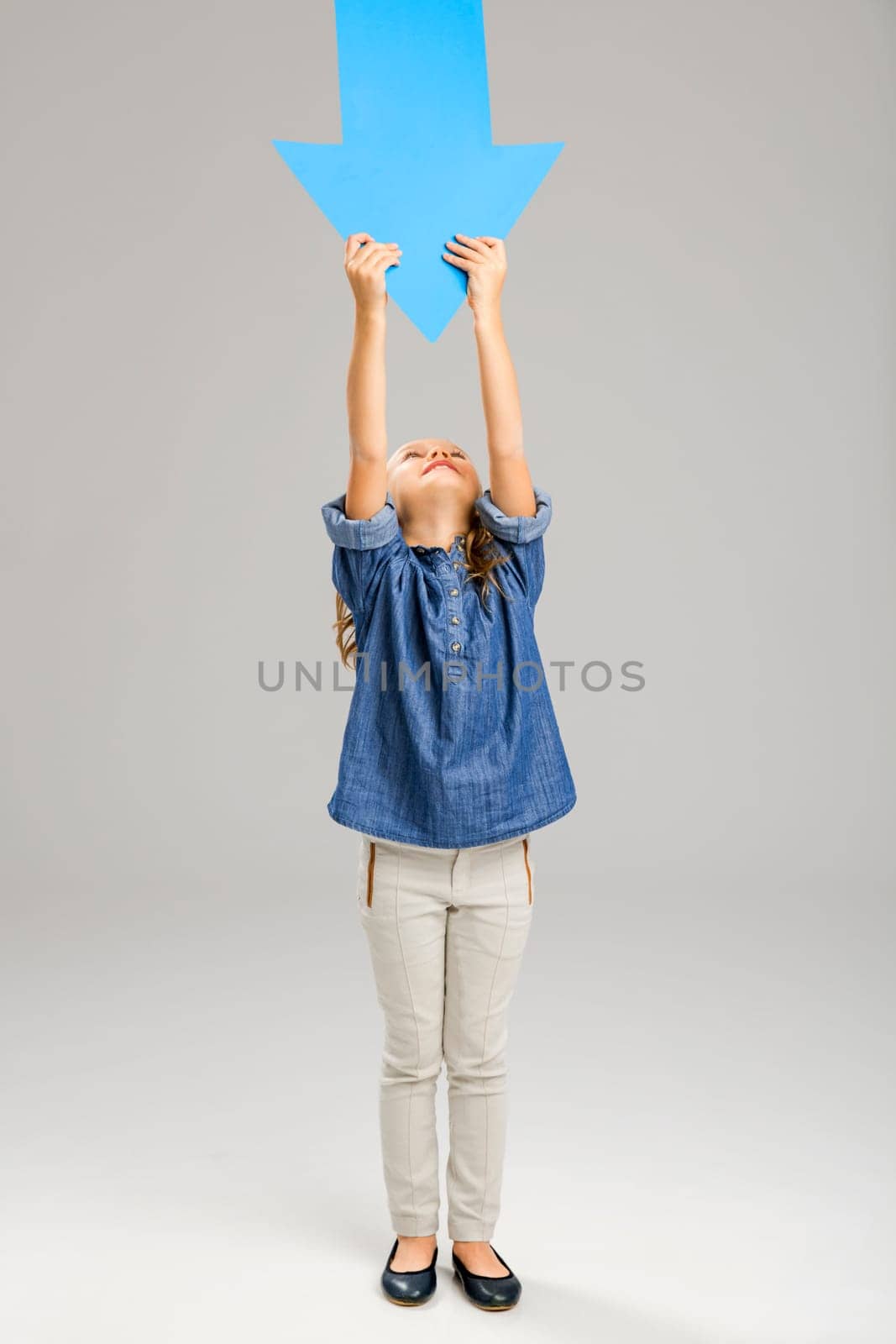Happy little girl holding a object card