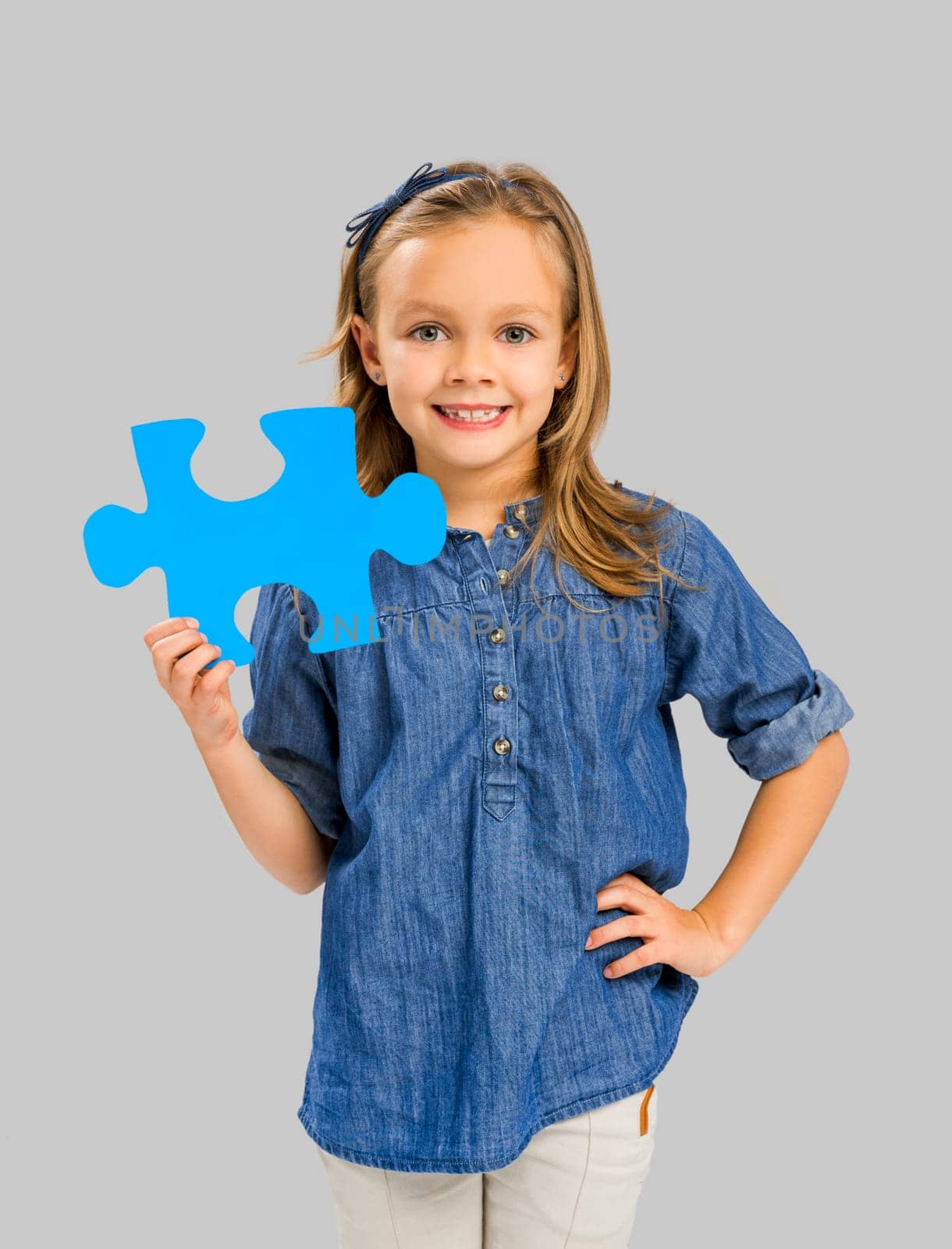 Happy little girl holding a object card