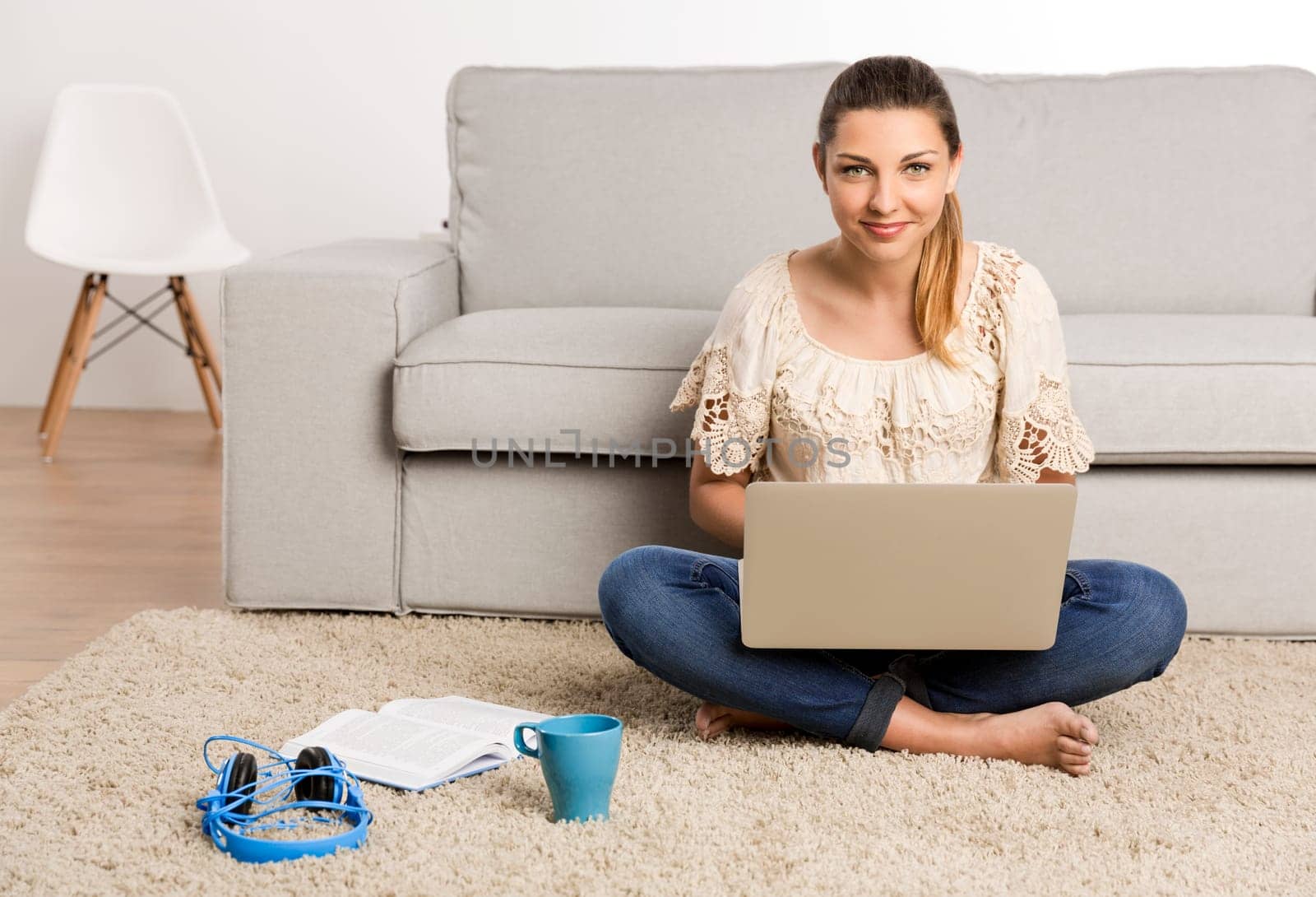 Beautiful woman at home working on her laptop