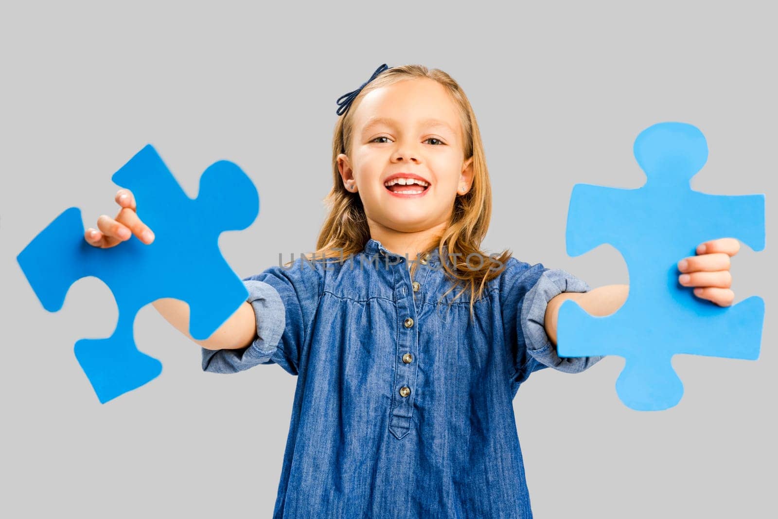 Happy little girl holding a object card
