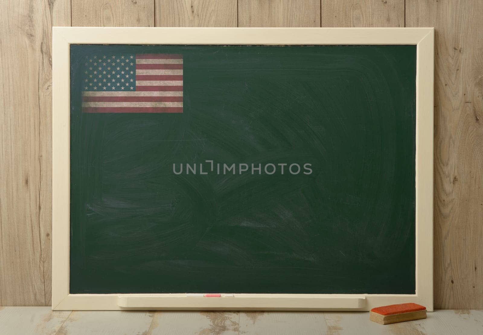 School board on wooden background with American flag