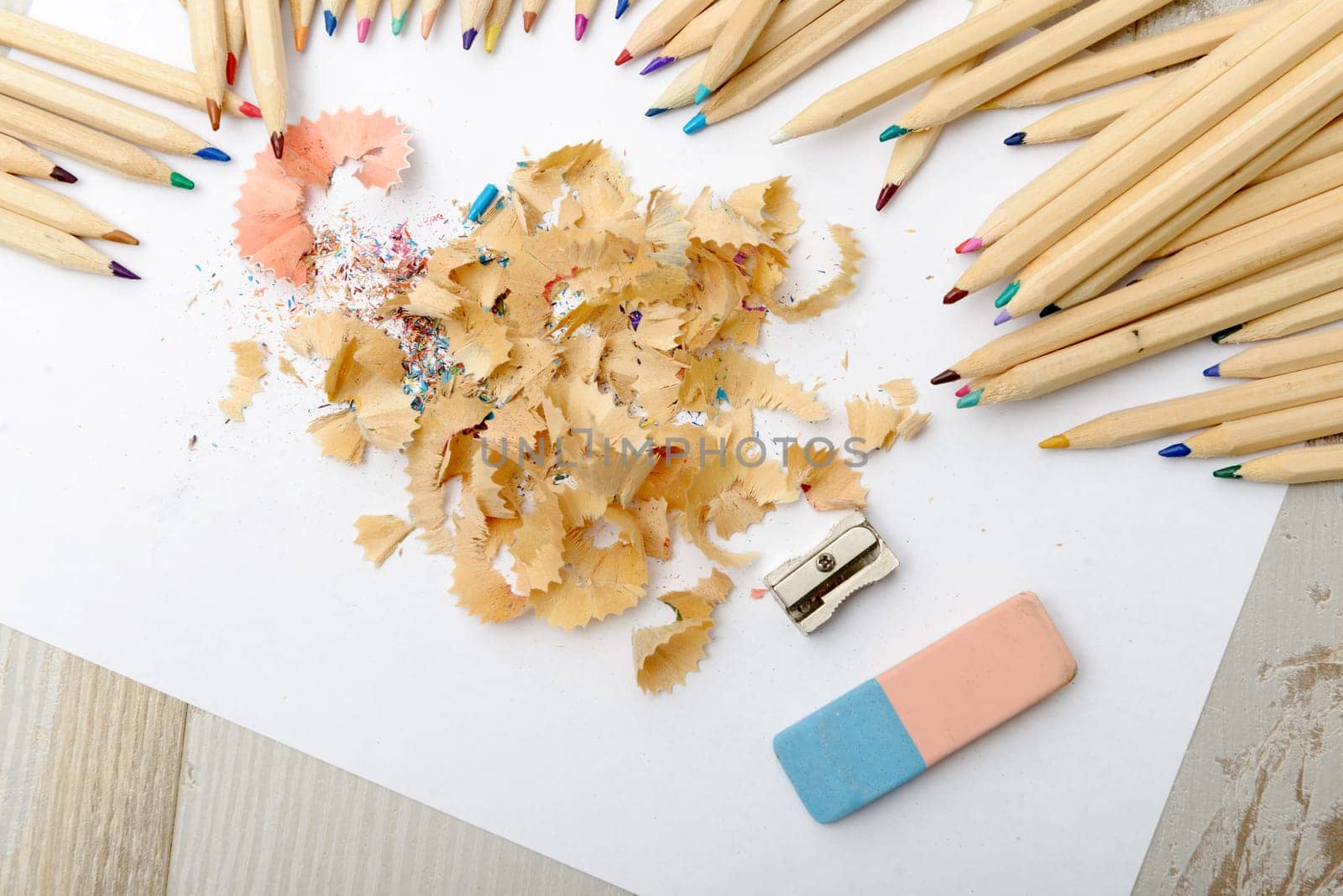 the colored pencils, eraser and pencil sharpener