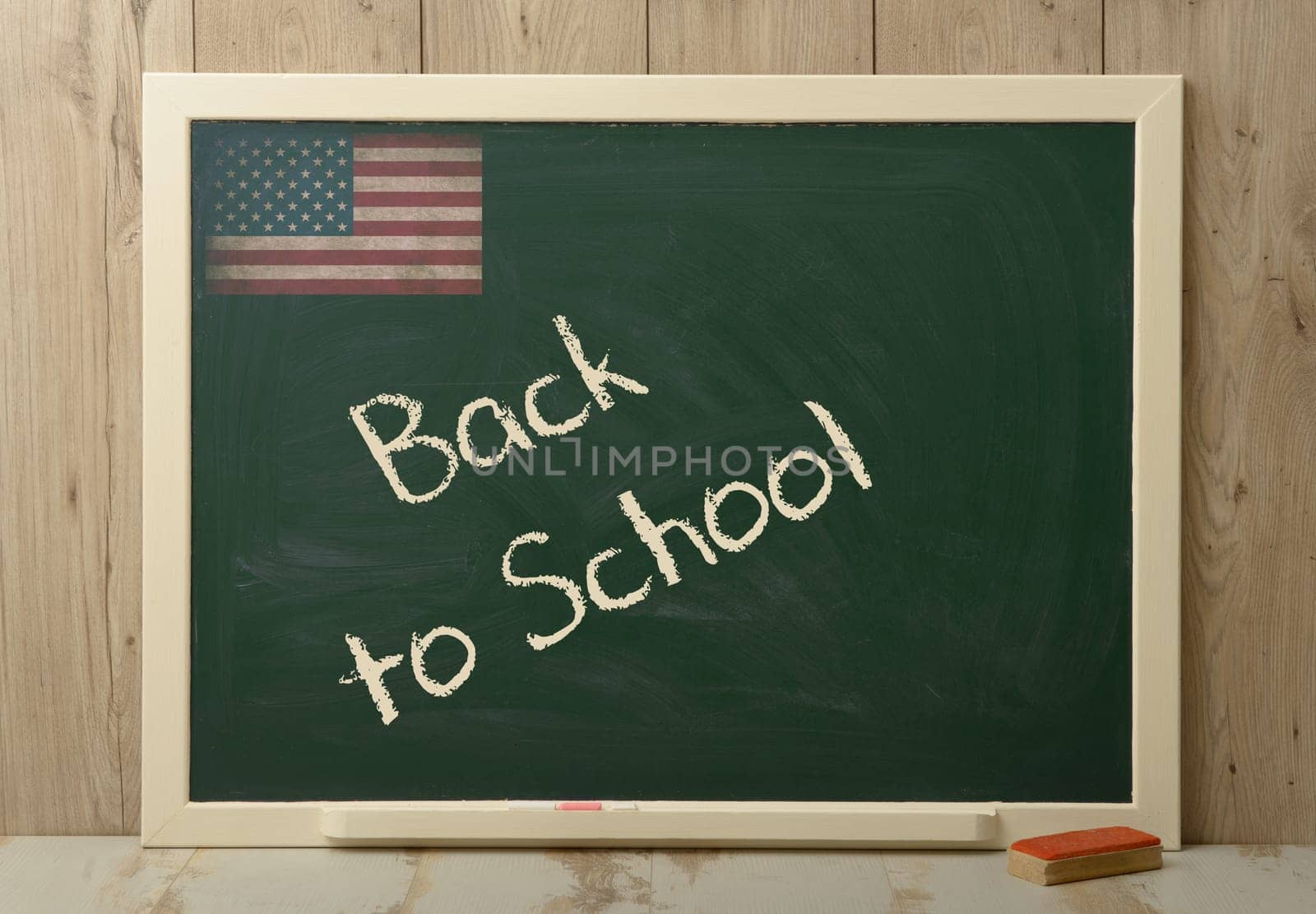 back to school written on a green blackboard