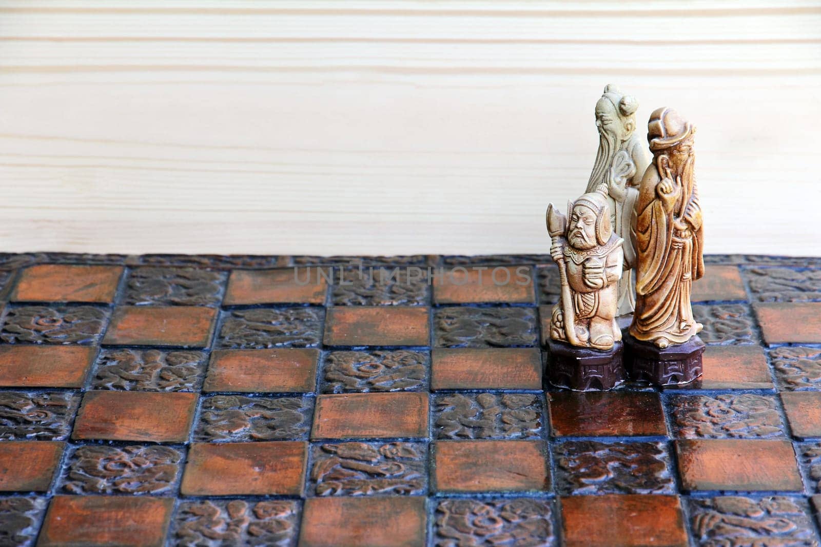 Three chess pieces on a chessboard. Together and cohesion in the game and in life
