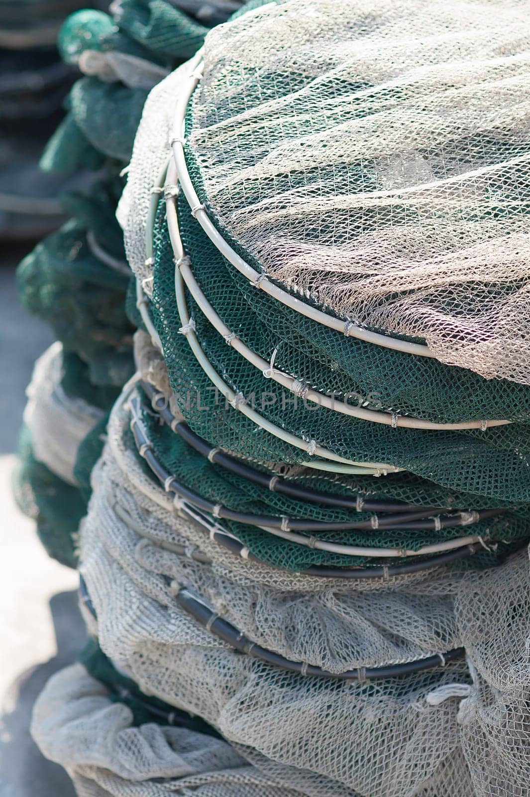Pots in nylon mesh suitable for fishing in the lagoon piled on the pier