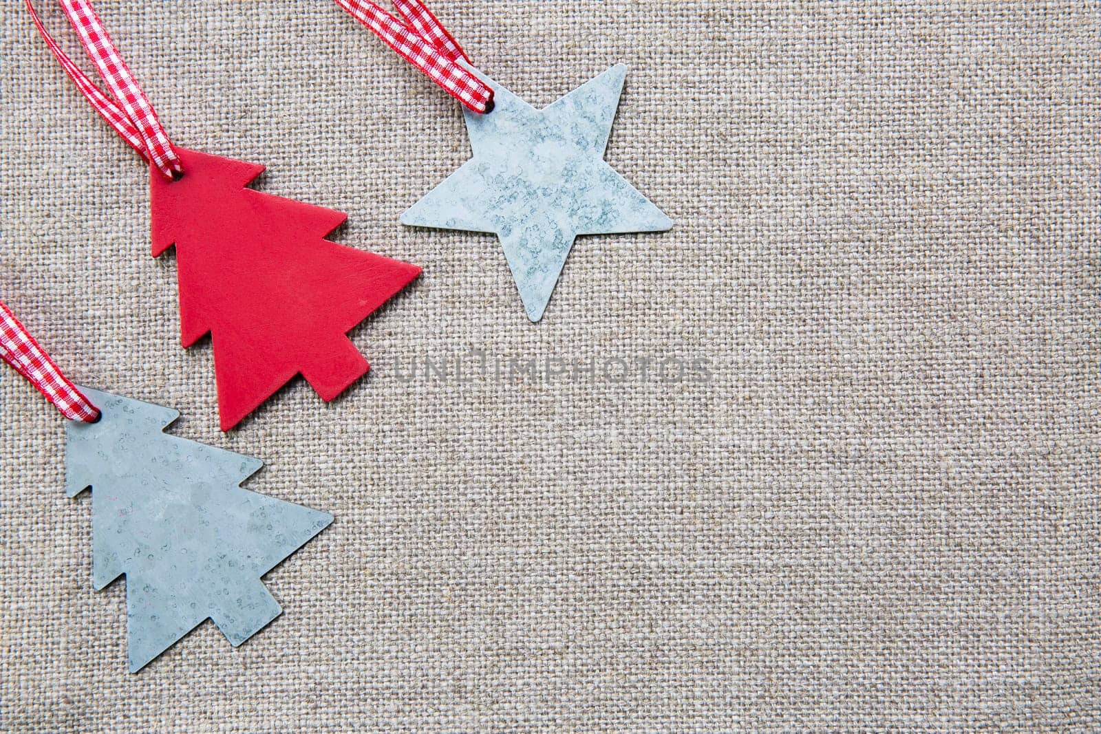 Christmas ornaments on linen background with copy space.