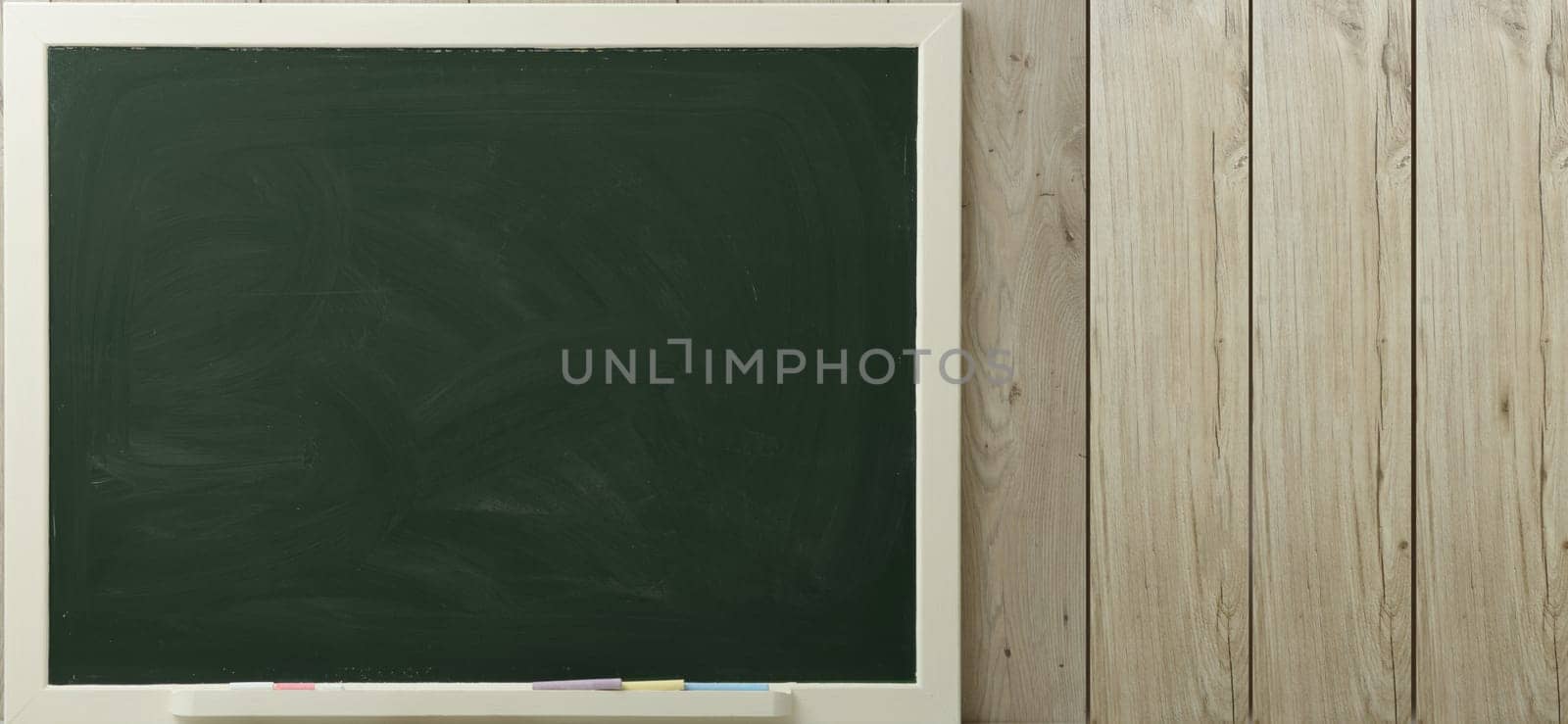 a green blackboard on a wooden background