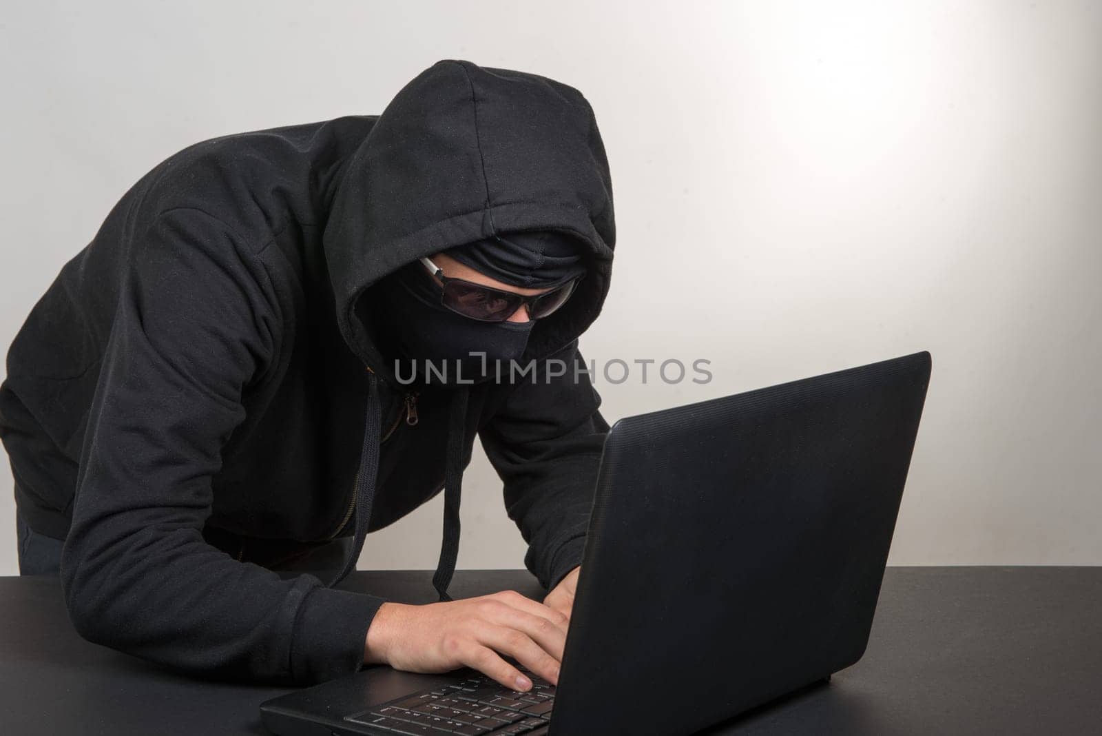 hacker with a hood and black goggles