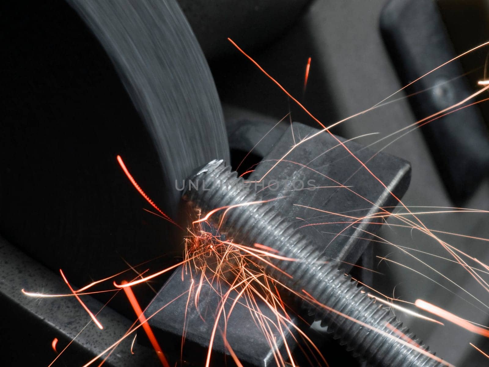 Spark flight of a metal rod on a rotating grinding wheel