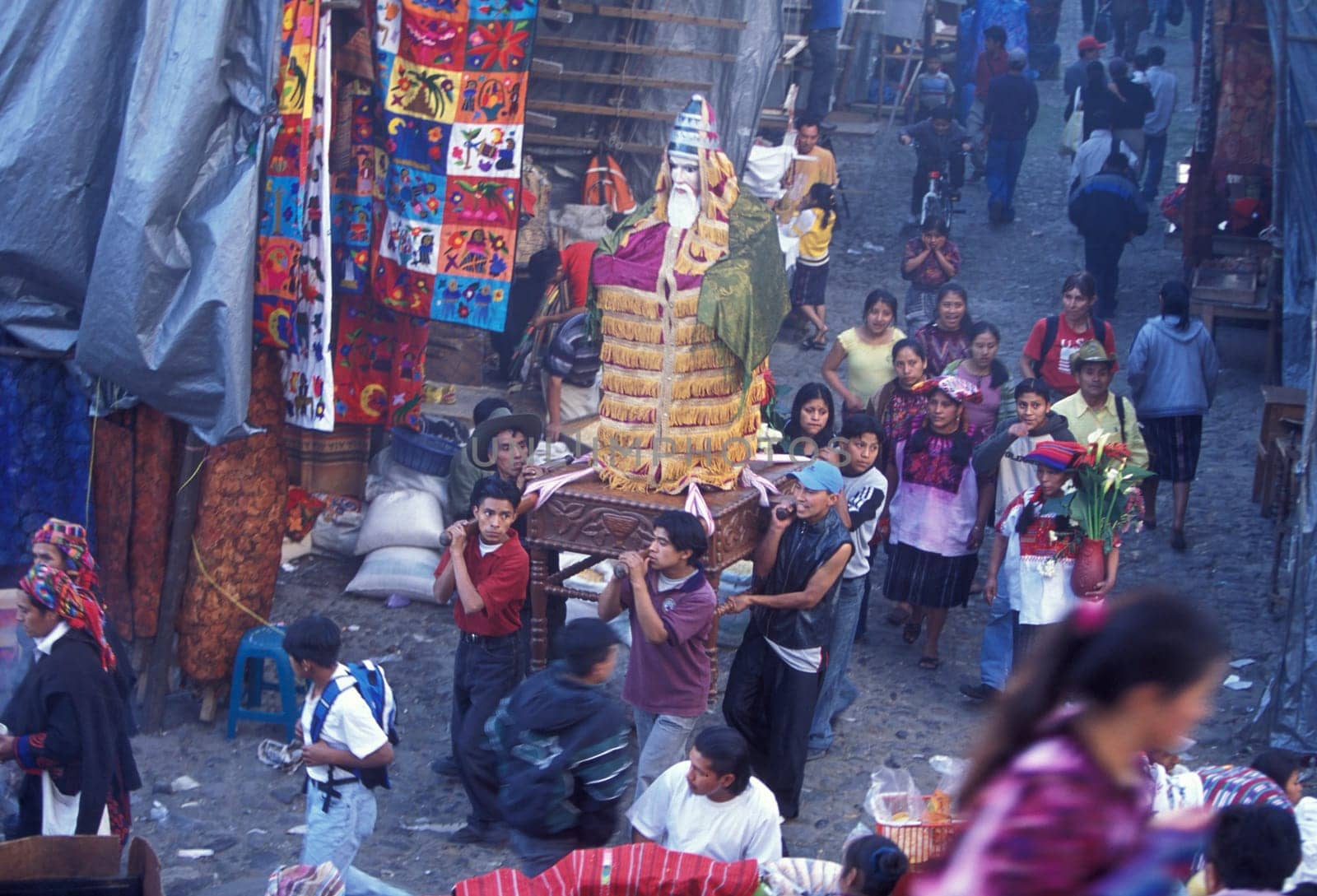 A relogion procession with people in traditional clotes at the Market in the Village of Chichi or Chichicastenango in Guatemala in central America.