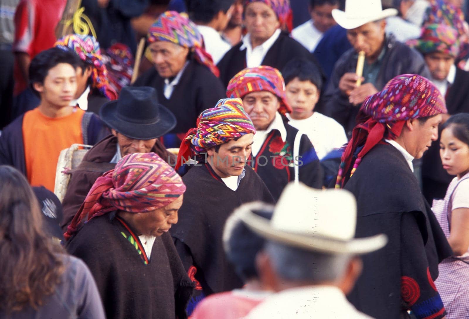 A relogion procession with people in traditional clotes at the Market in the Village of Chichi or Chichicastenango in Guatemala in central America.