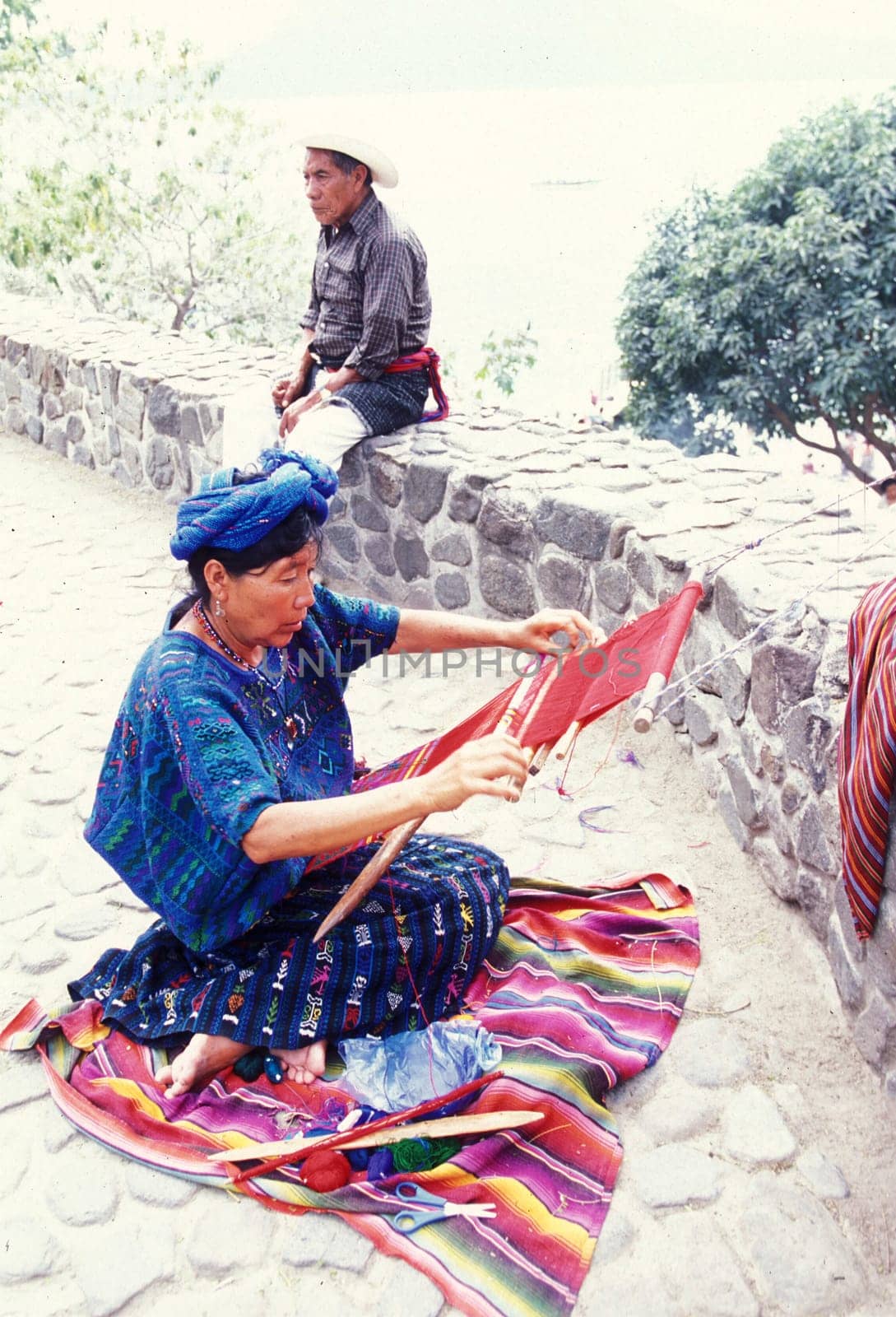 a women works in traditional clotes in the Village of  Panajachel in Guatemala in central America.