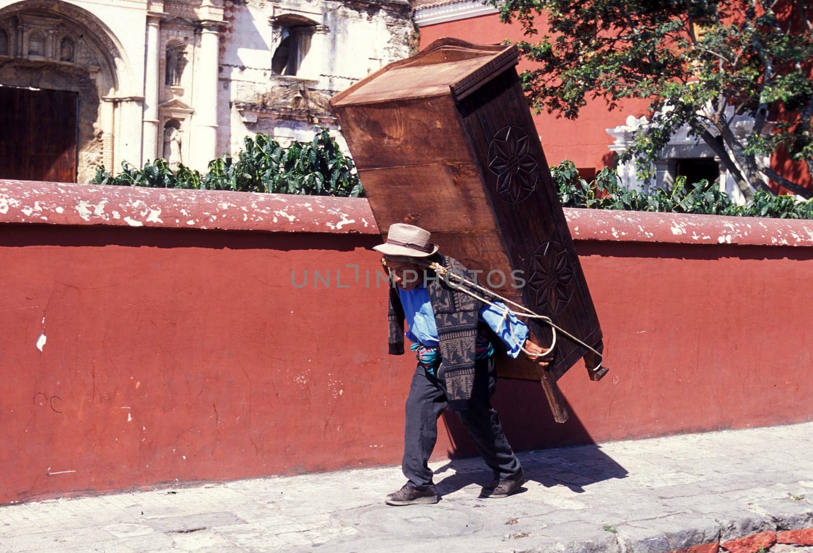 a men works in the old town in the city of Antigua in Guatemala in central America.