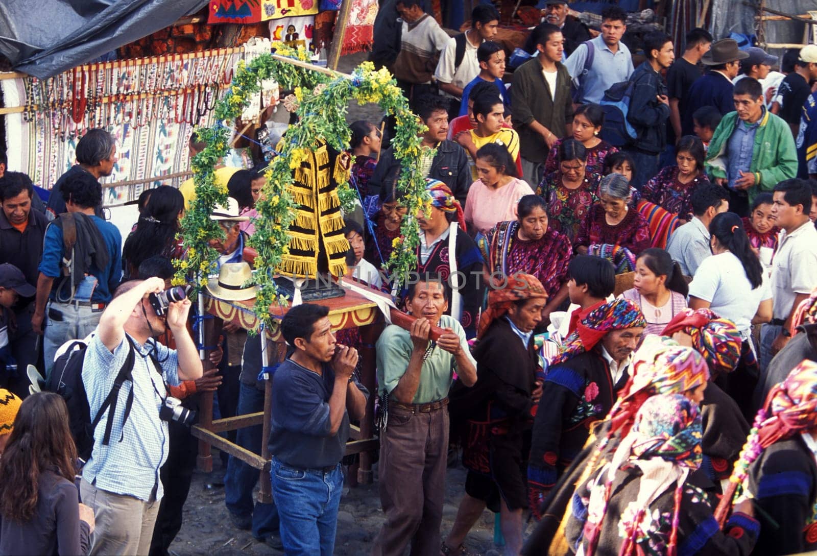 A relogion procession with people in traditional clotes at the Market in the Village of Chichi or Chichicastenango in Guatemala in central America.