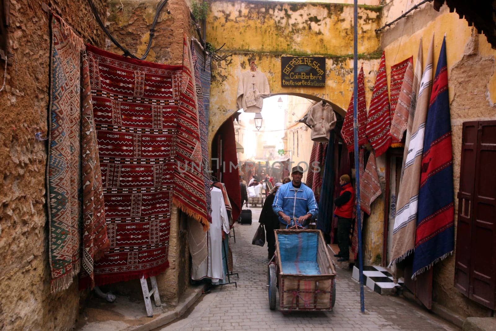 a smal Marketroad in the Medina of old City in the historical town of Fes in Morocco in north Africa.