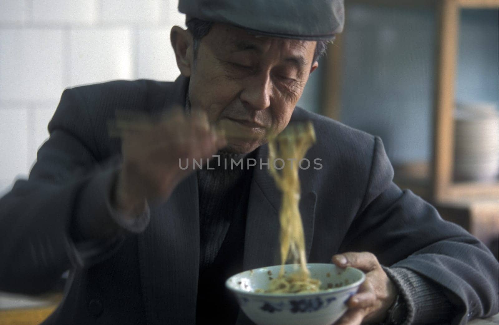 people with fast food on the Market streets of Chongqing in the province of Sichuan in china in east asia.
