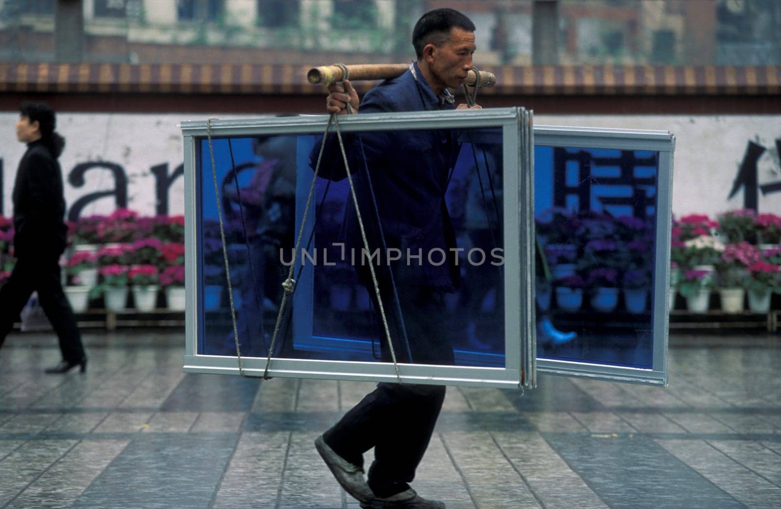 Transport people at the main square in the city of Chongqing in the province of Sichuan in china in east asia.