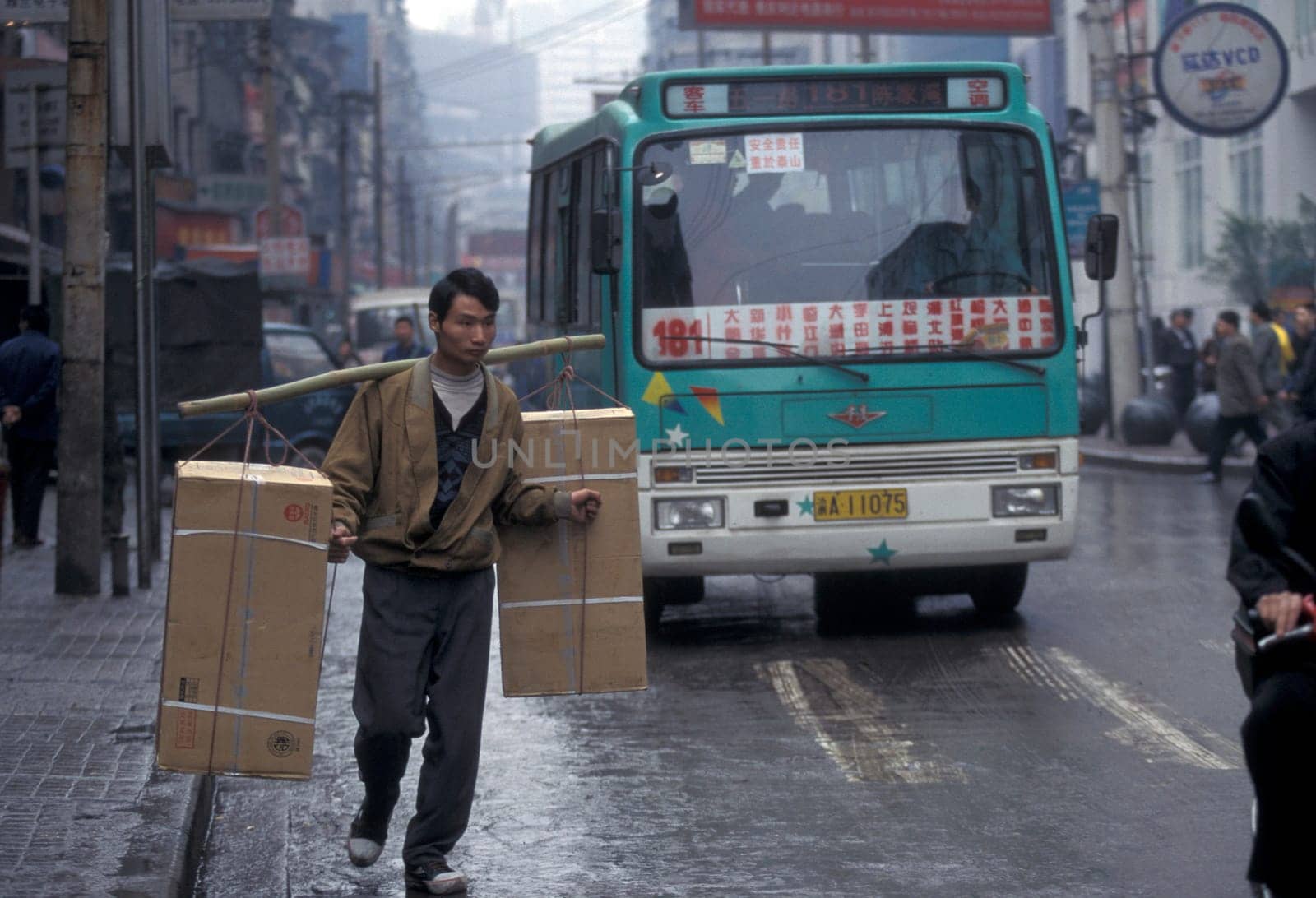 Transport people at the main square in the city of Chongqing in the province of Sichuan in china in east asia.