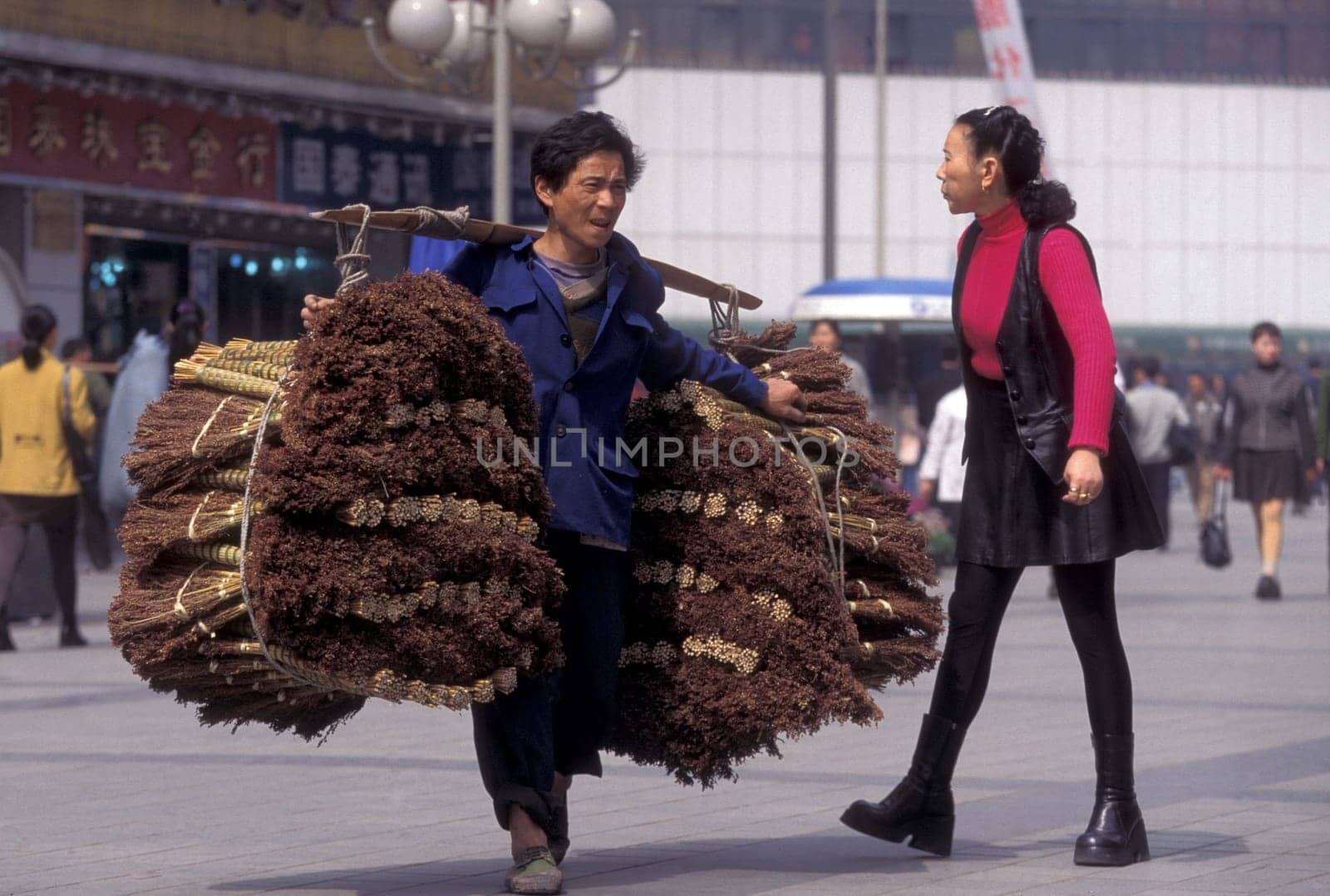 Transport people at the main square in the city of Chongqing in the province of Sichuan in china in east asia.