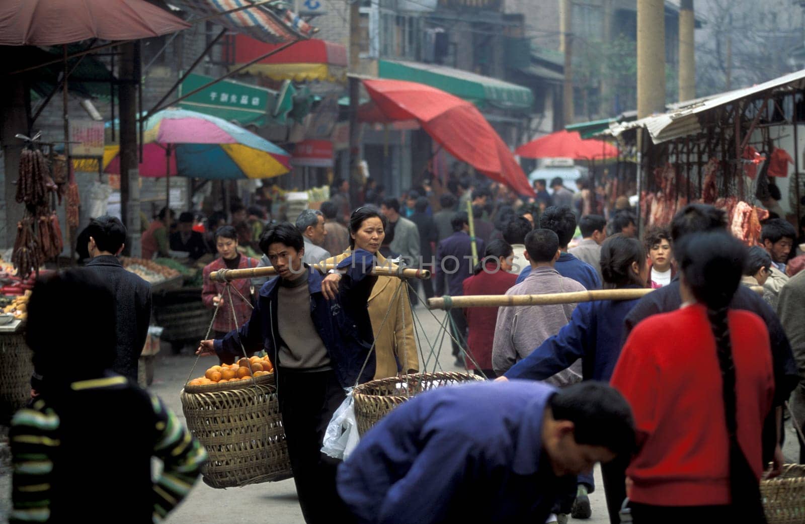 Transport people at the main square in the city of Chongqing in the province of Sichuan in china in east asia.