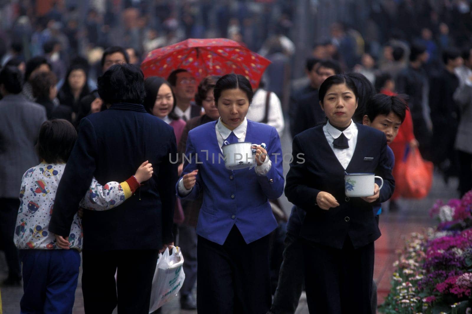 People with tea at the main square in the city of Chongqing in the province of Sichuan in china in east asia.