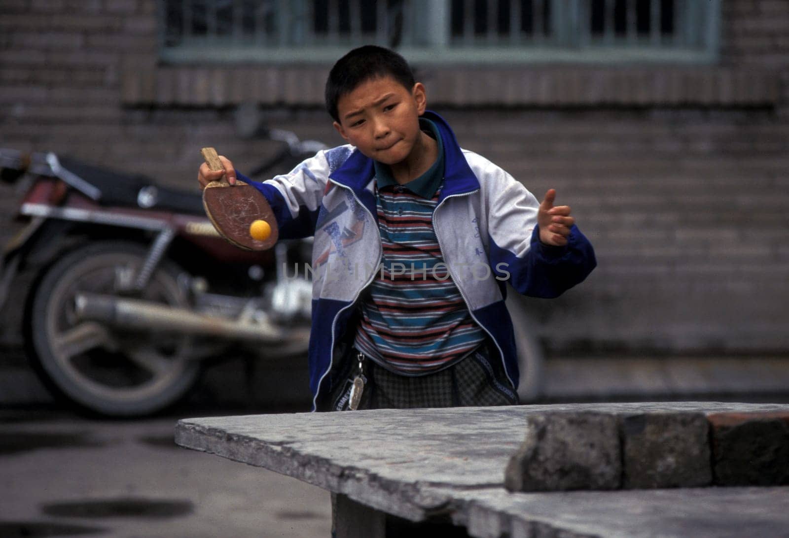 cilder play table tennis in the city of wushan on the yangzee river near the three gorges valley up of the three gorges dam project in the province of hubei in china.