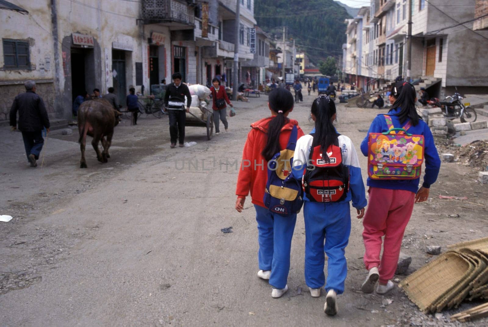 Childern on the way to school in the town of Yangshou near the city of Guilin in the Province of Guangxi in china in east asia.
