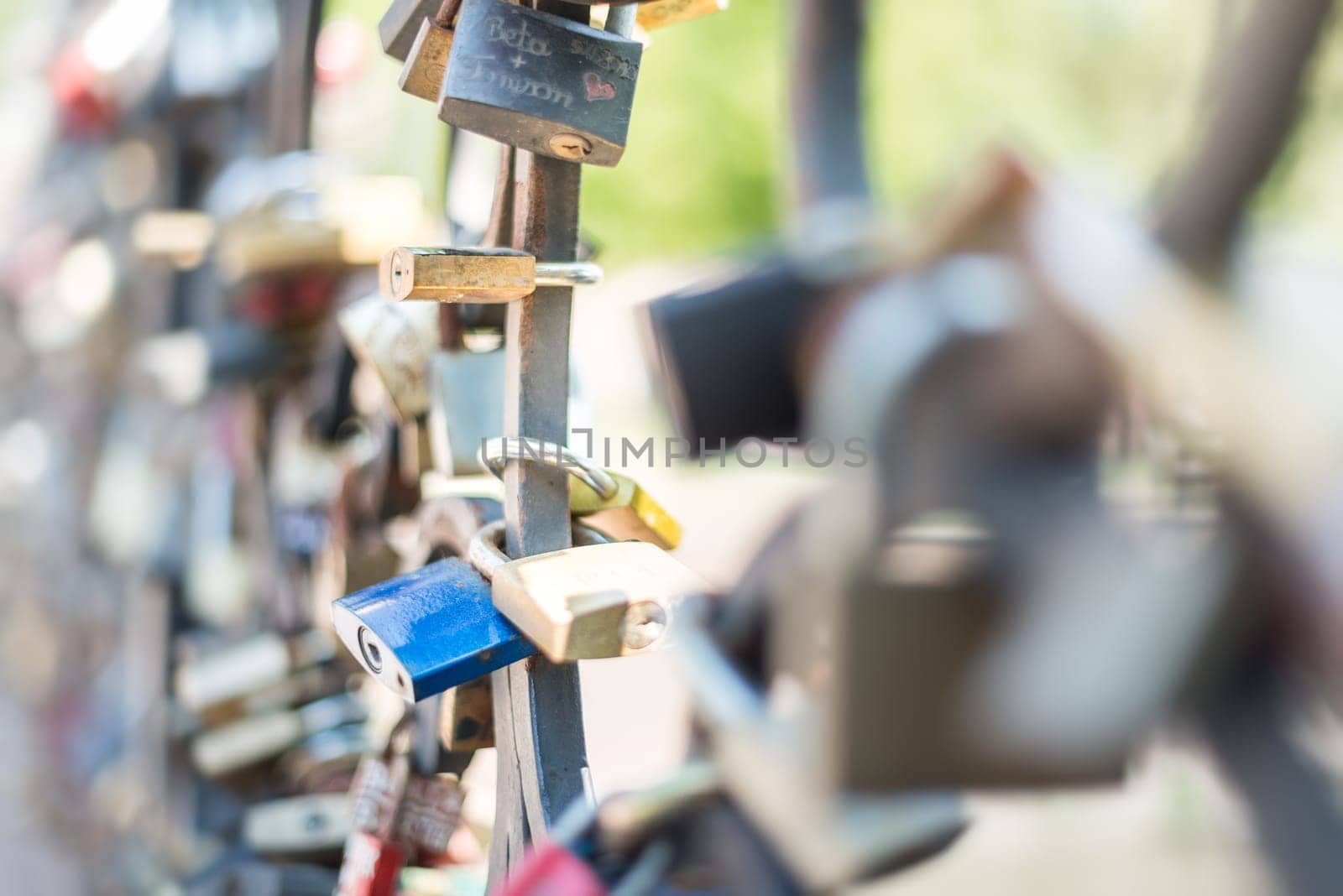 Love padlocks attached to the bridge. Europe. Wedding and marriage tradition.