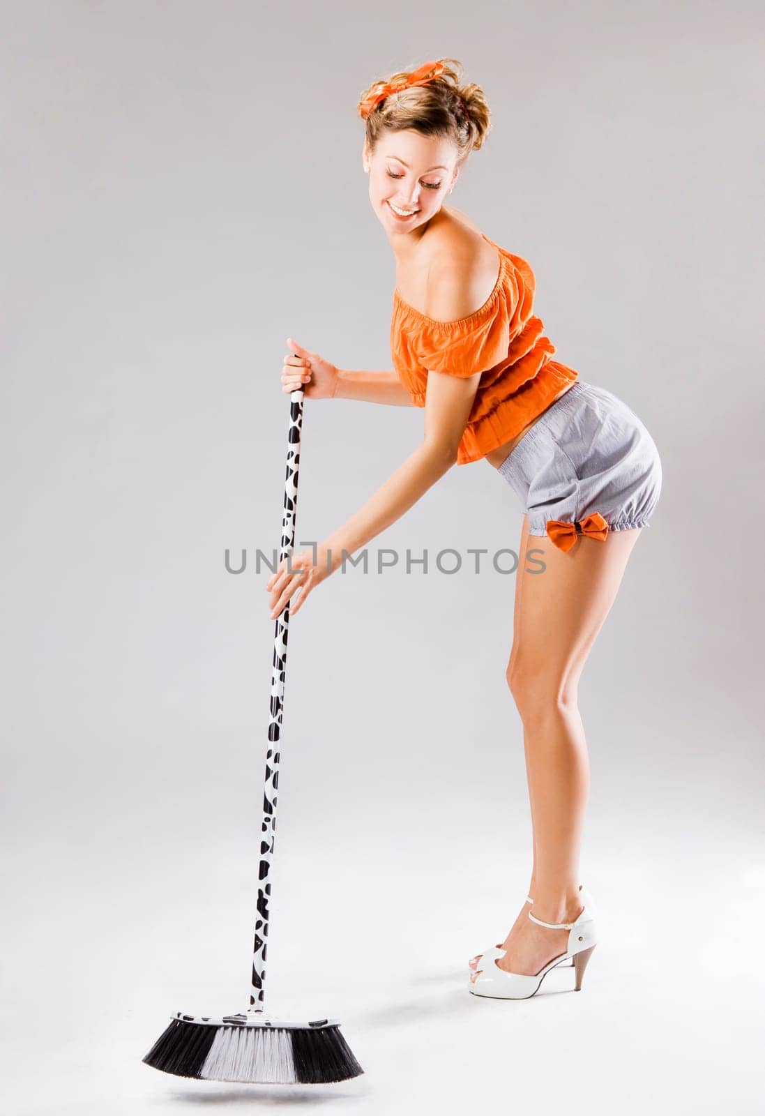 pinup funny young sexy woman sweeping