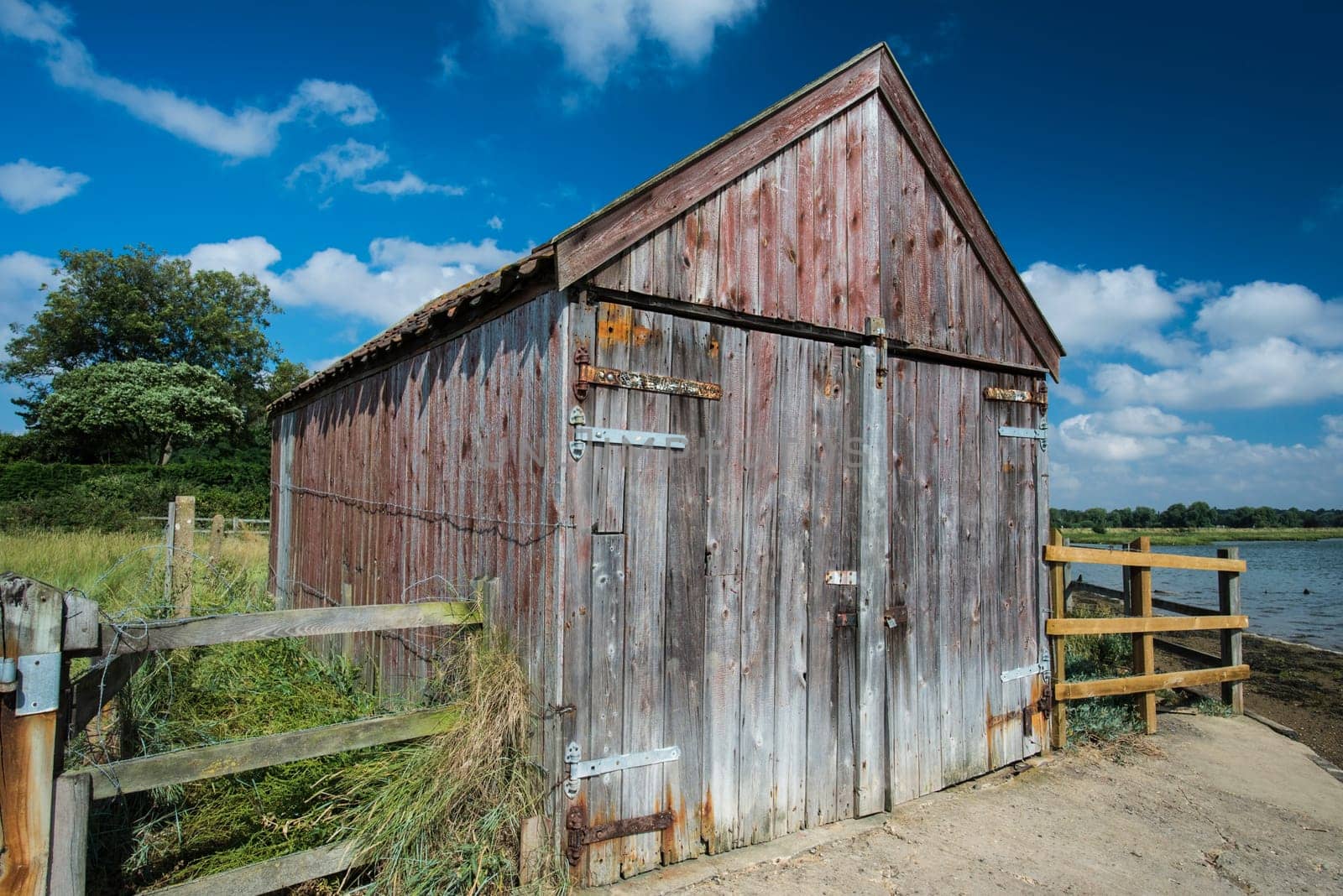 Old wooden boathouse on the edge of a waterway