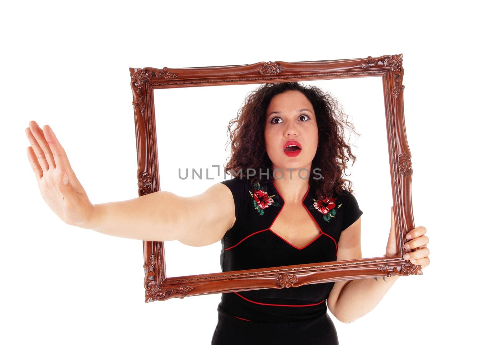 A angry woman looking trough a picture frame stretching one hand.out say NO, isolated for white background..