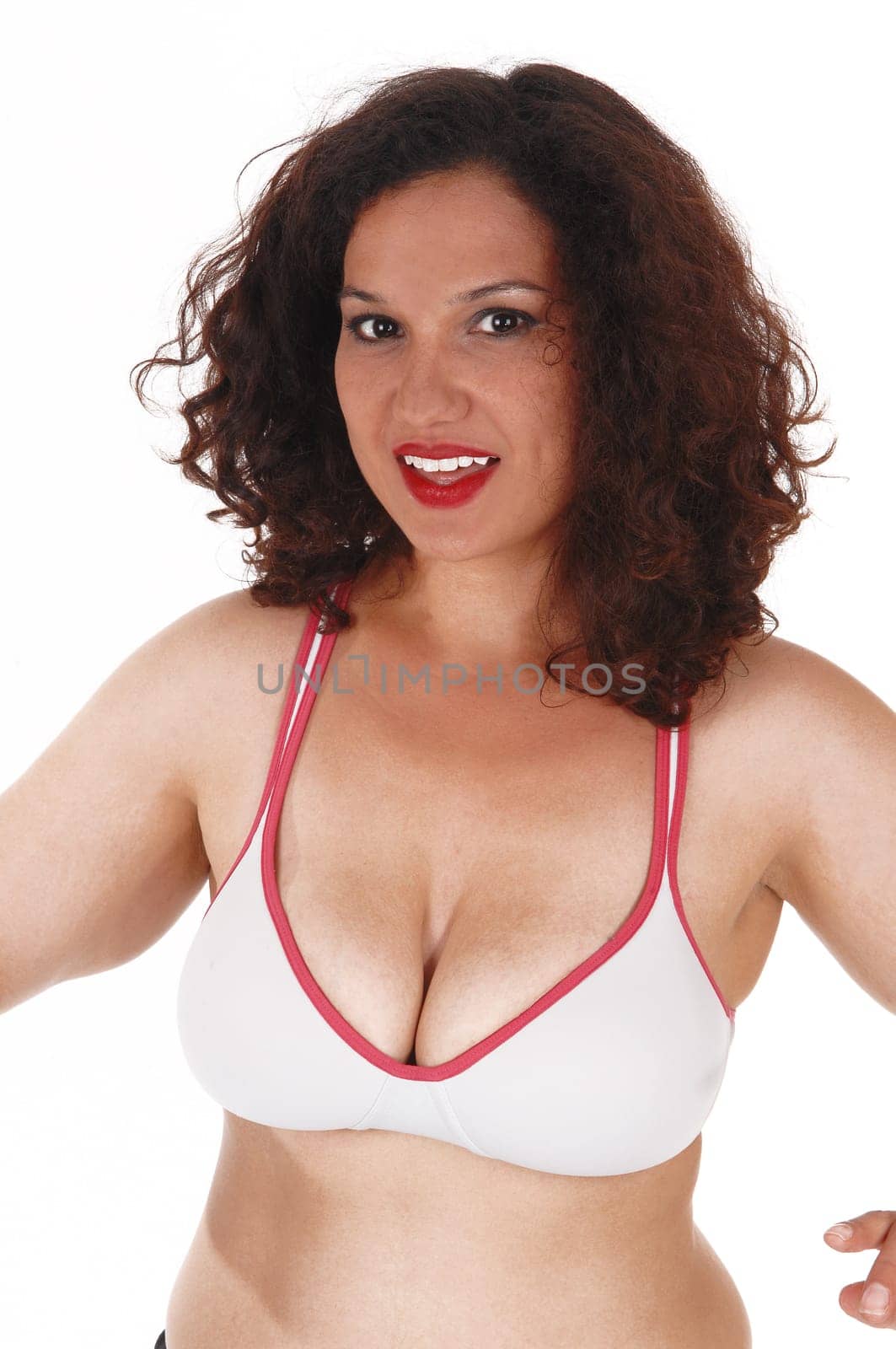 A lovely young woman standing in a workout bra and big boob's.isolated for white background..