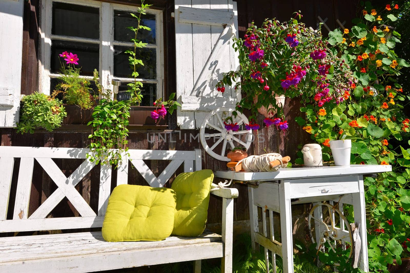 Garden hut in summer with lots of flowers