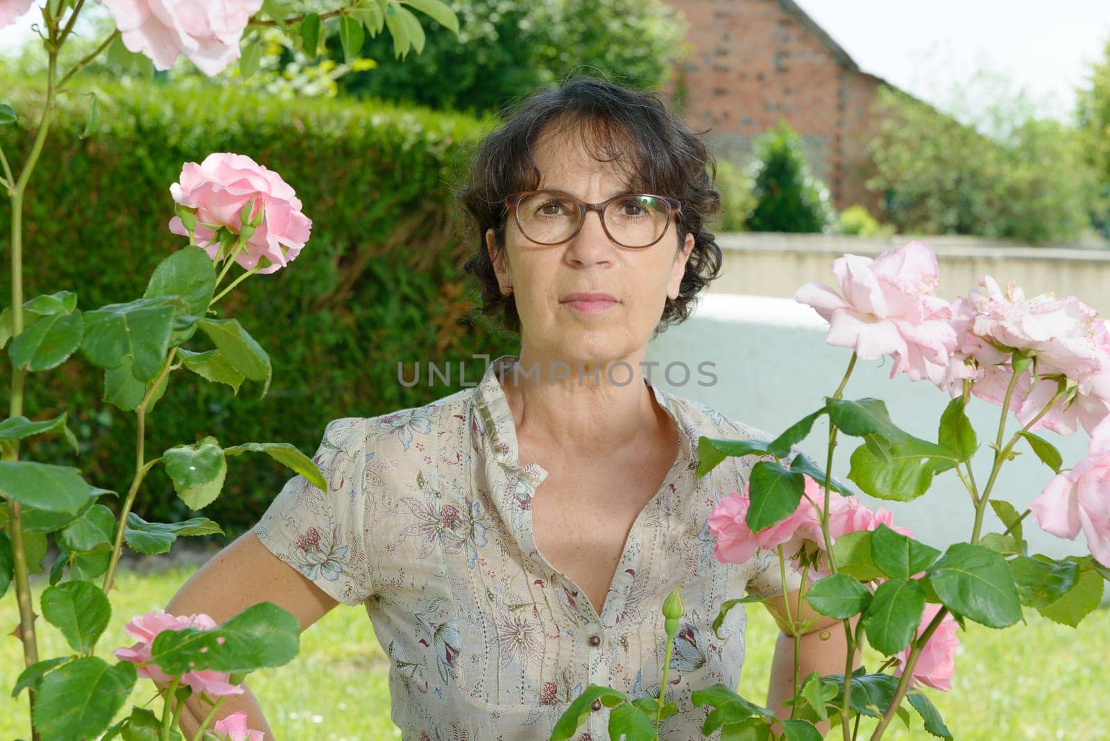 a middle aged woman with glasses in the garden