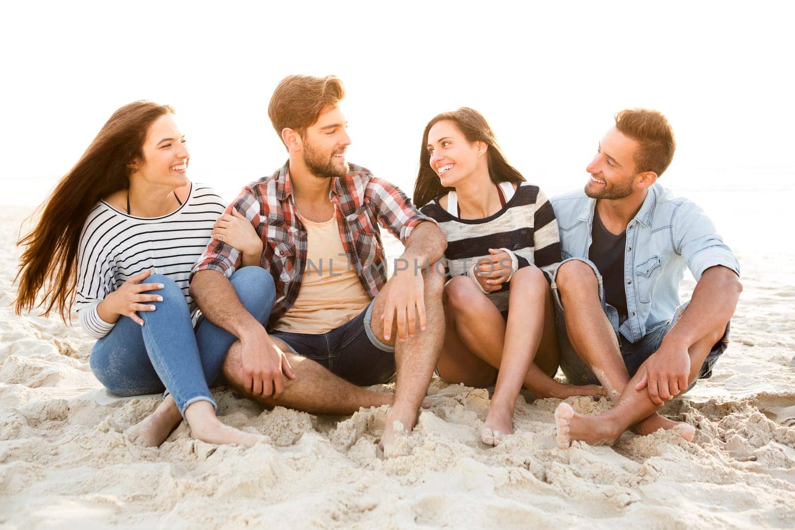 Group of friends at the beach having fun