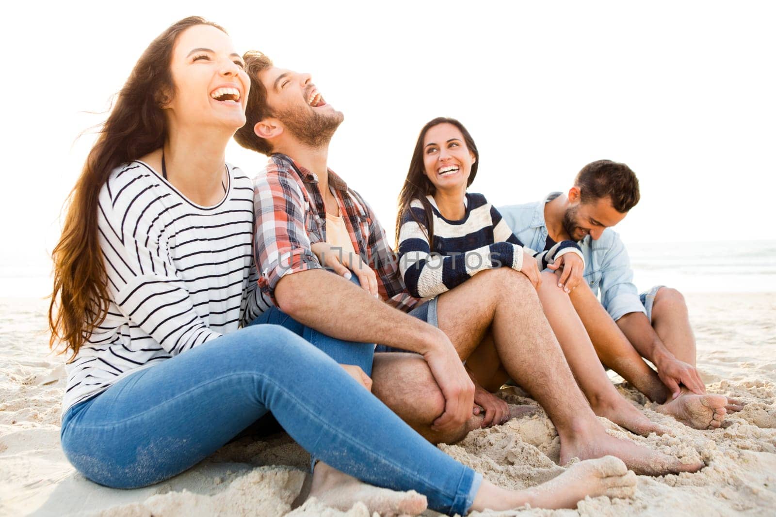 Group of friends at the beach having fun