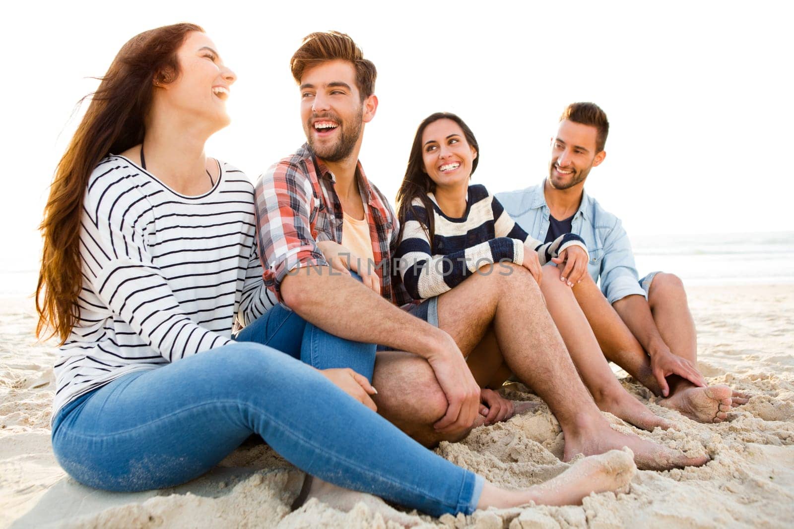 Group of friends at the beach having fun