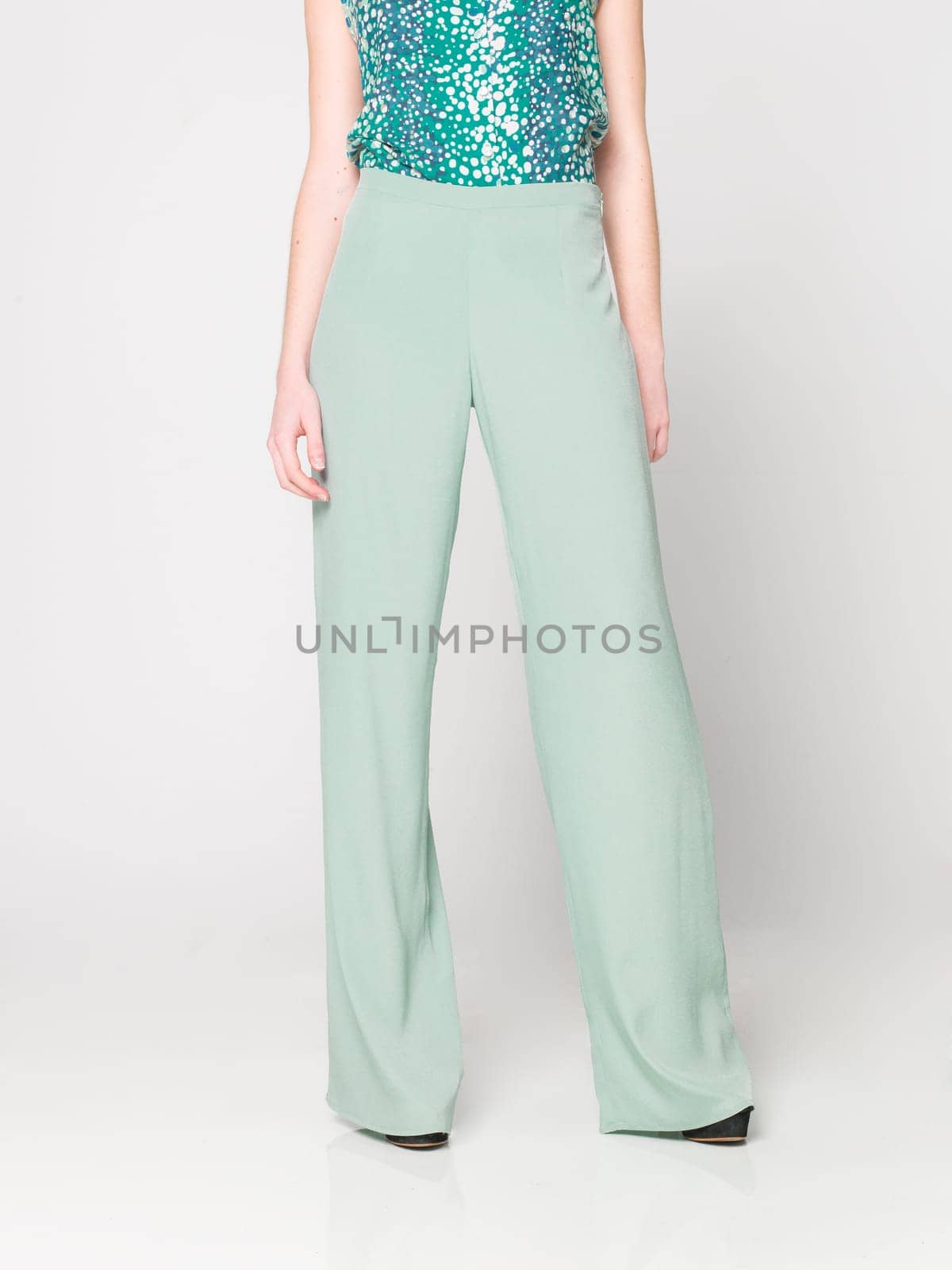 a beautiful model wearing feminine clothes in clear background