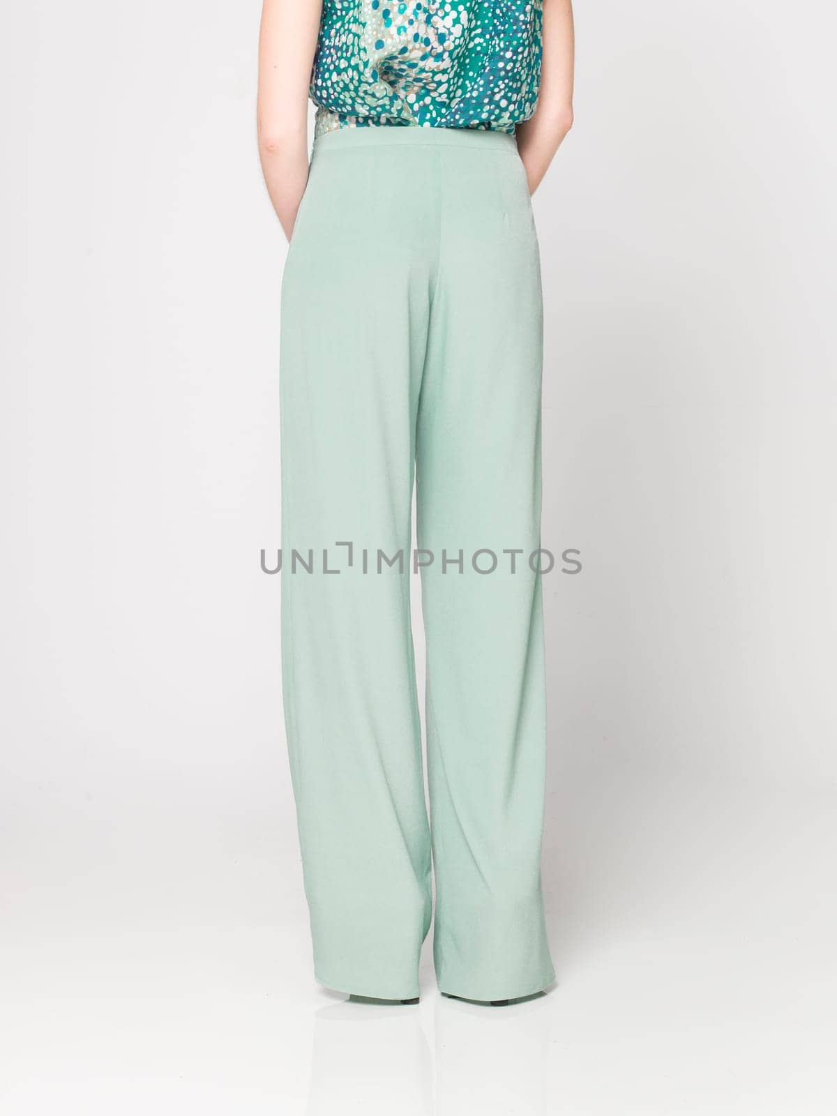 a beautiful model wearing feminine clothes in clear background