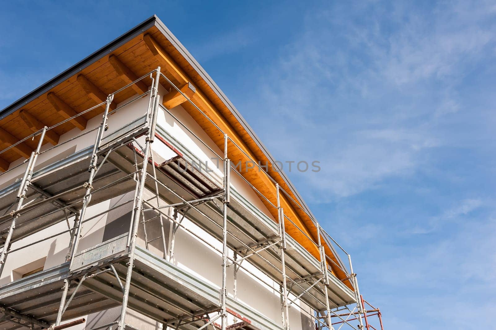 House under renovation with the scaffolding for bricklayers