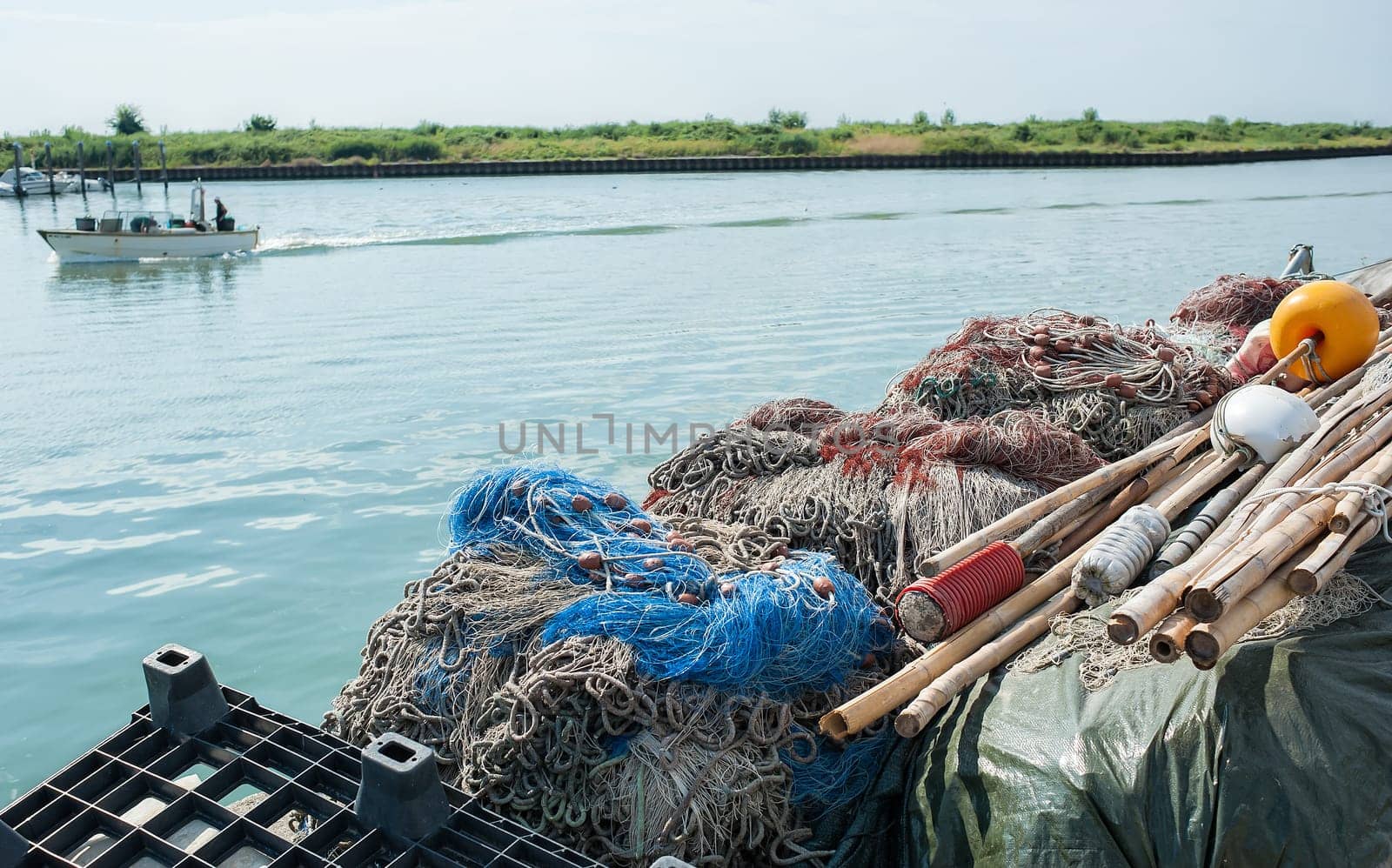 Fishing nets piled in a row on the pier