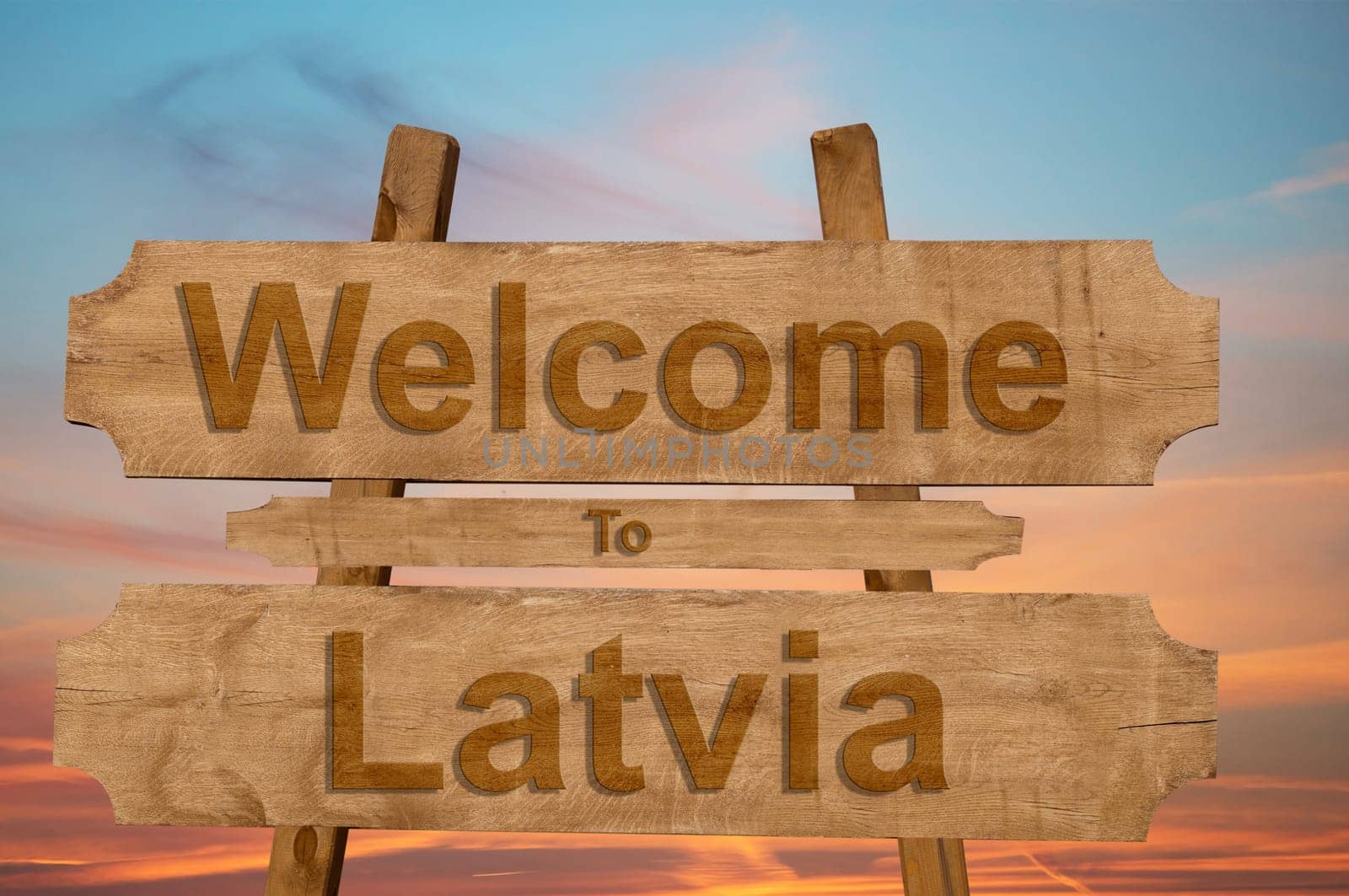 welcome to latvia sign on wood background