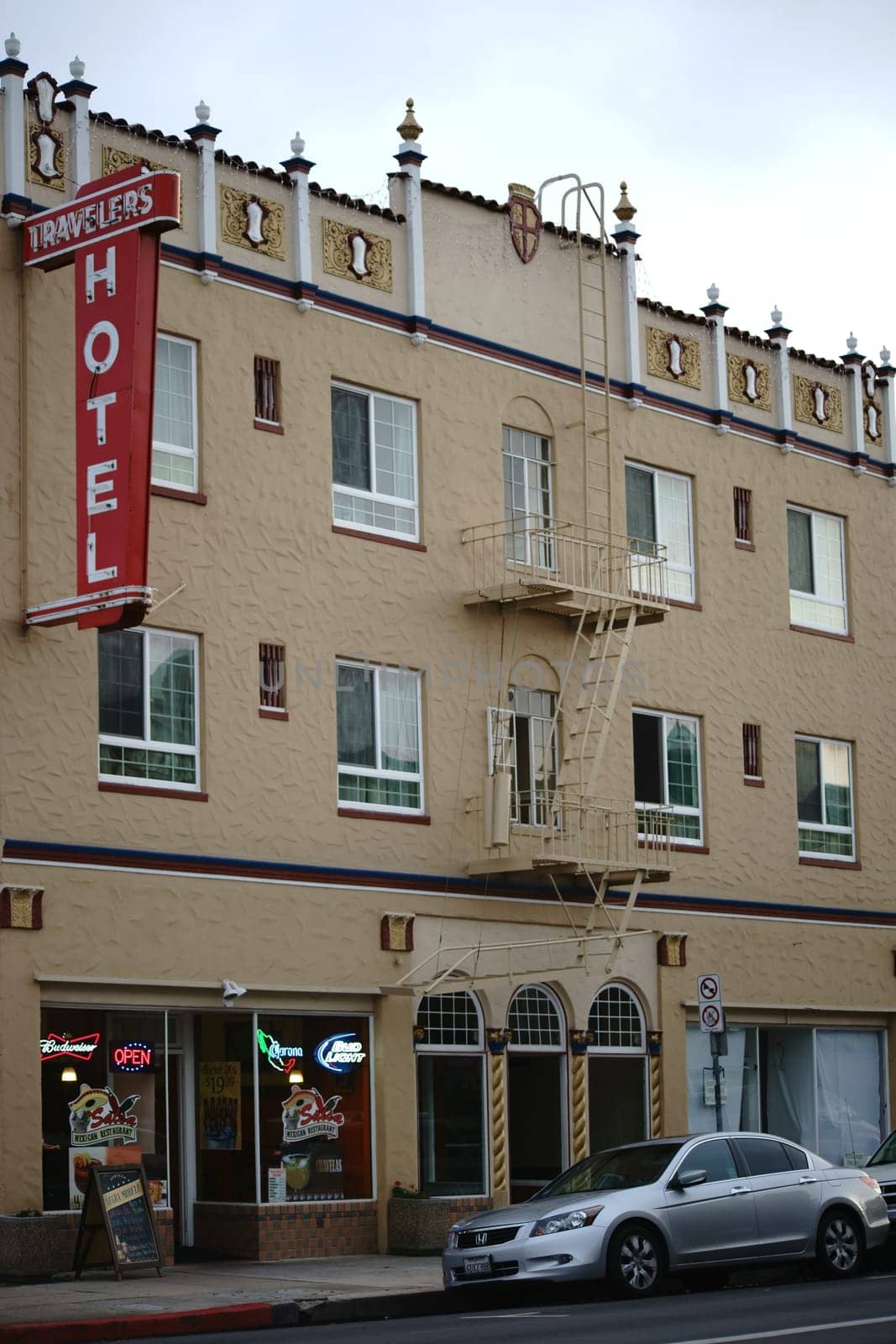 Salinas,United States - December 22,2015: Cars park in front of the Traveler Hotel and a Mexican restaurant on the ground floor on December 22,2015 in Salinas.