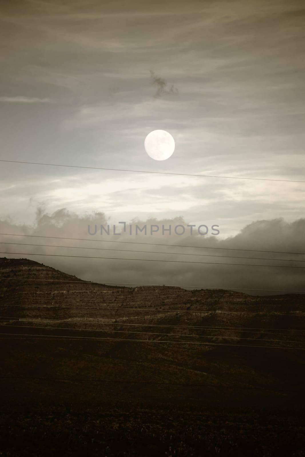 Cloud bands as well as the moon over the mountains between Amaragosa Valley and Las Vegas.