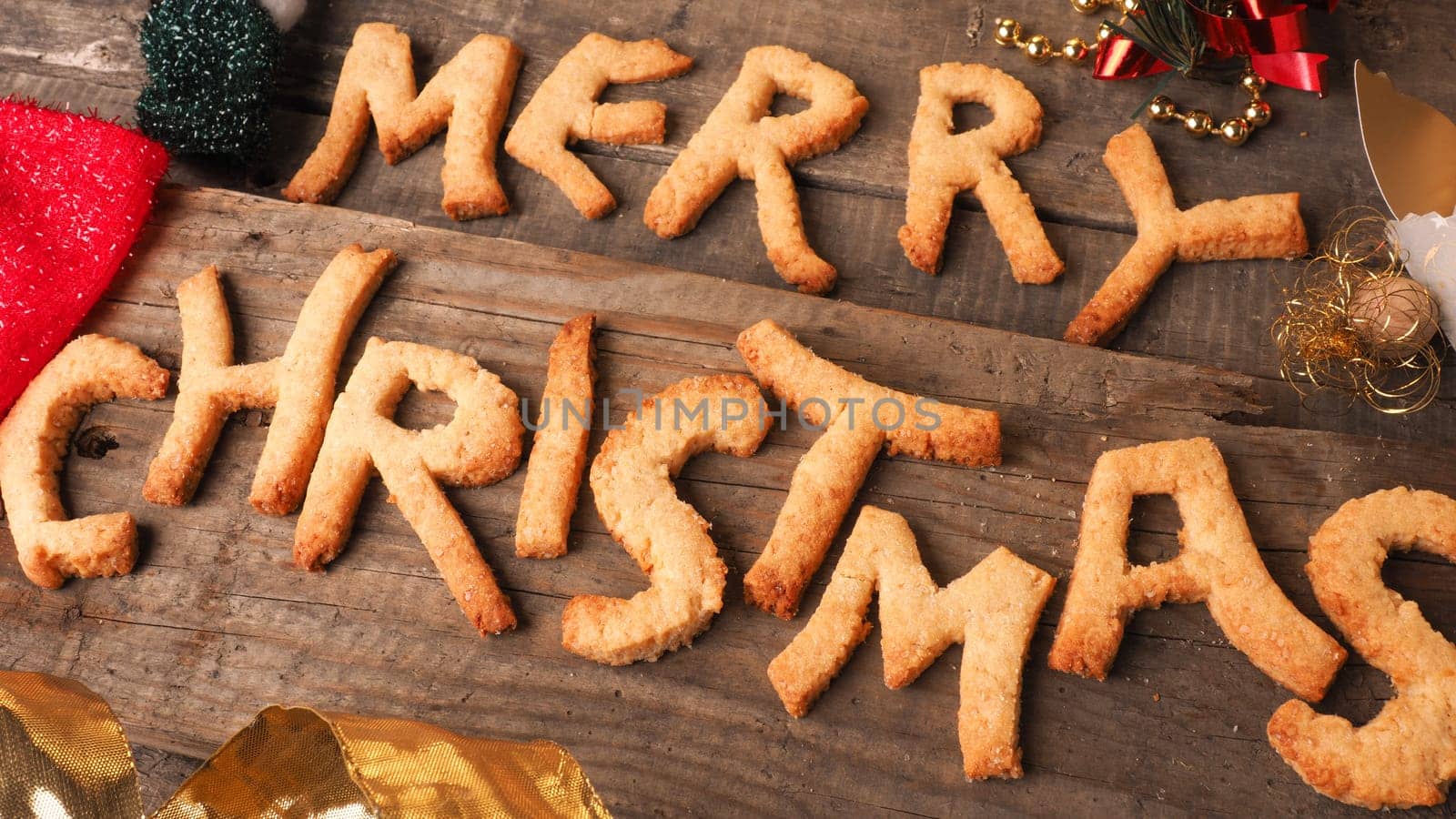 Sweet homemade cookies with the words Merry Christmas on an old wooden table
