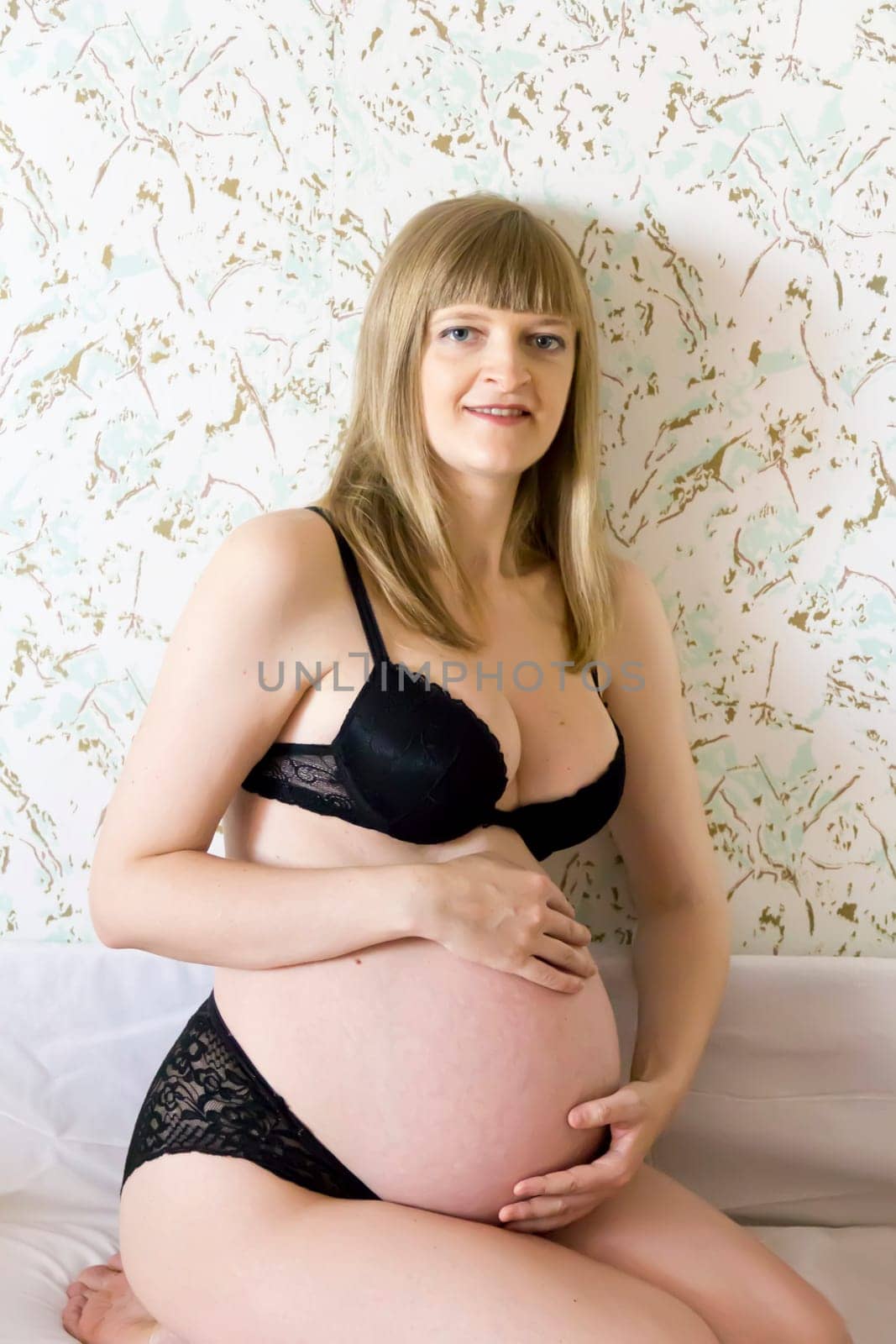 Image of pregnant woman in black underwear
