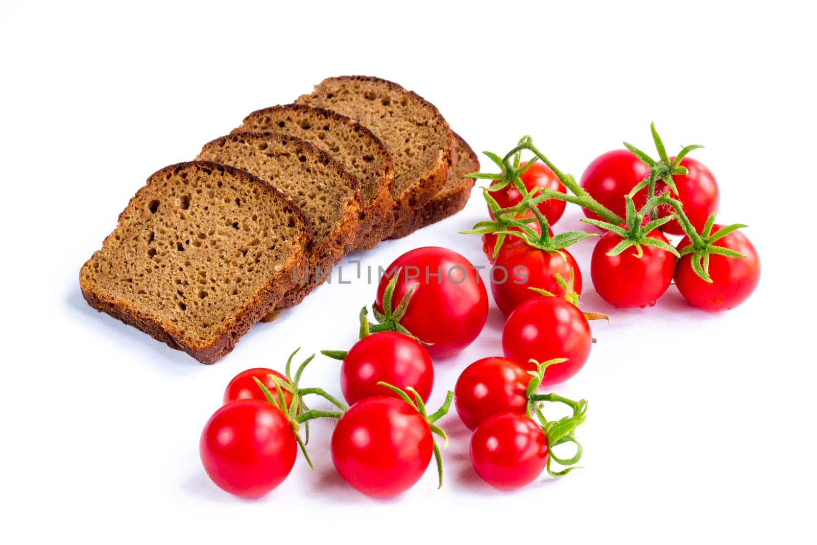 Composition of black bread and bunch of cherry tomatoes