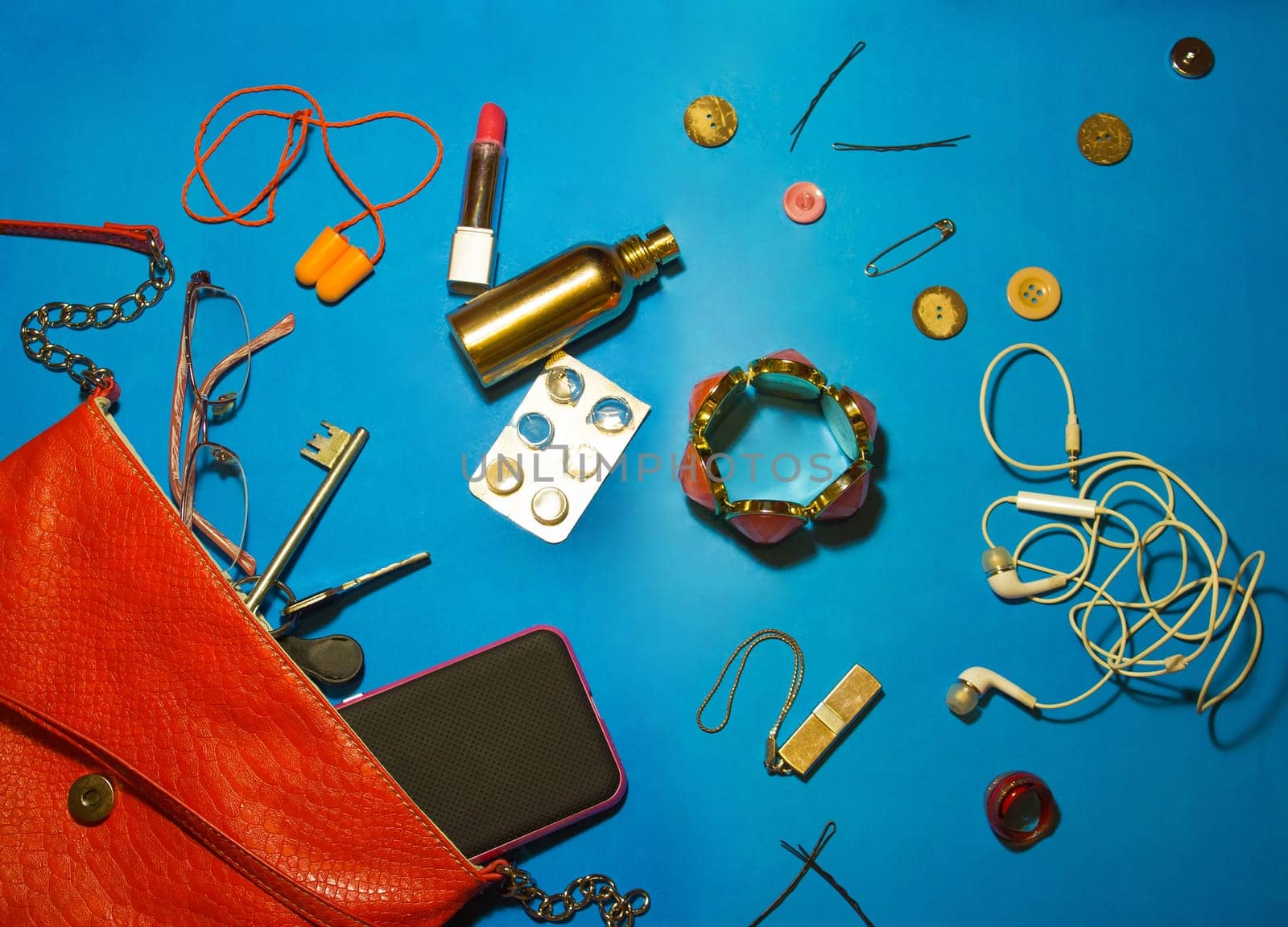 Top view of female accessories and smart phone on yellow background