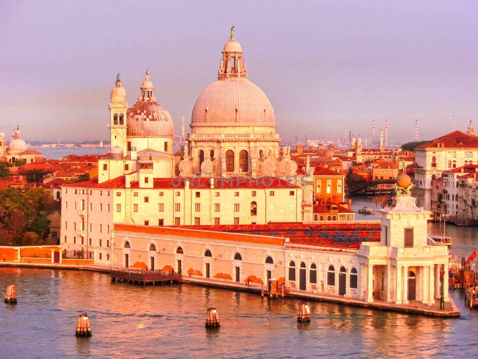 Beautiful view from Grand Canal on colorful facades of old medieval houses in Venice, Italy at sunset
